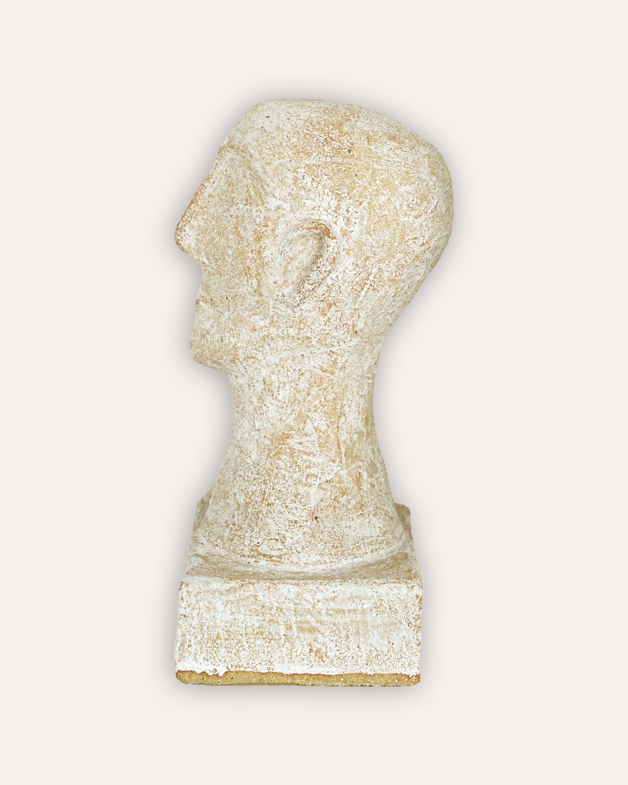 Stone sculpture of a head on a white background
