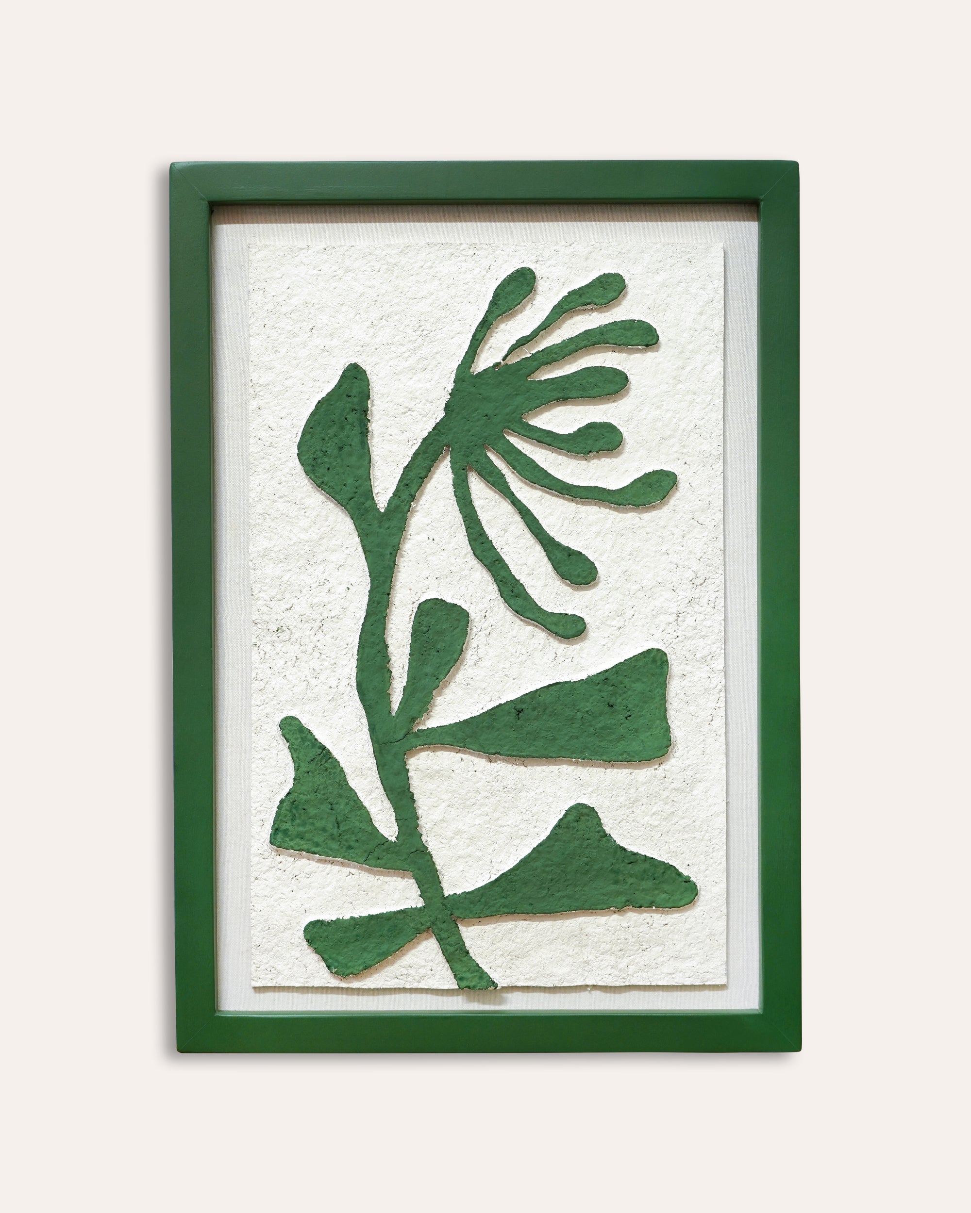 Framed artwork with green leaf pattern on a white background