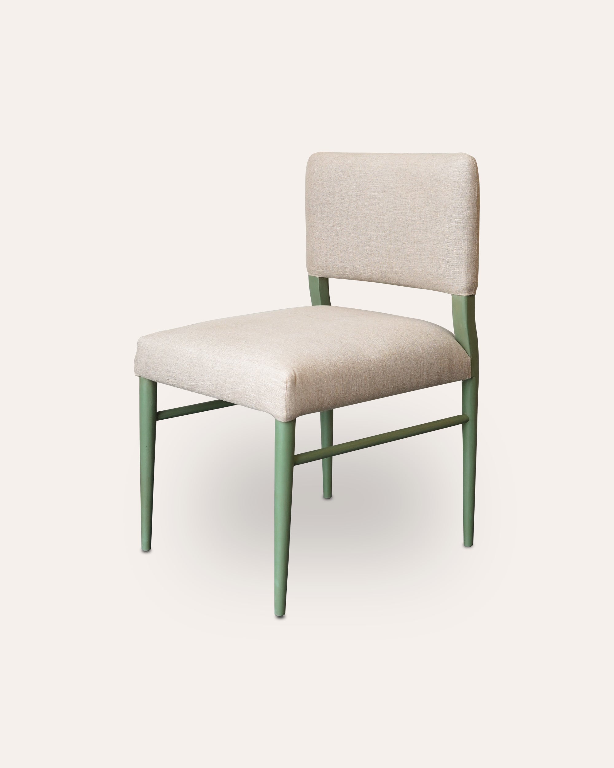 Beige chair with green legs on a white background