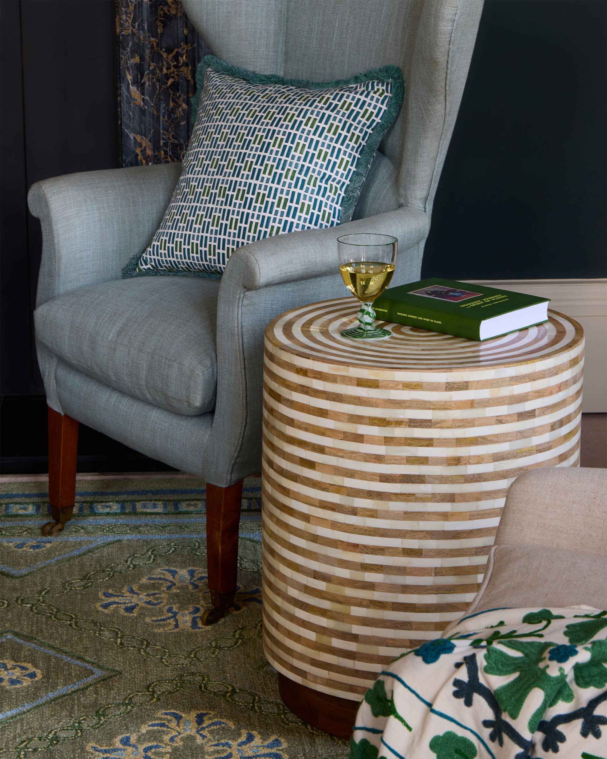 Ladrillo Tile Print Fringed Cushion - Blue & Green, on a chair