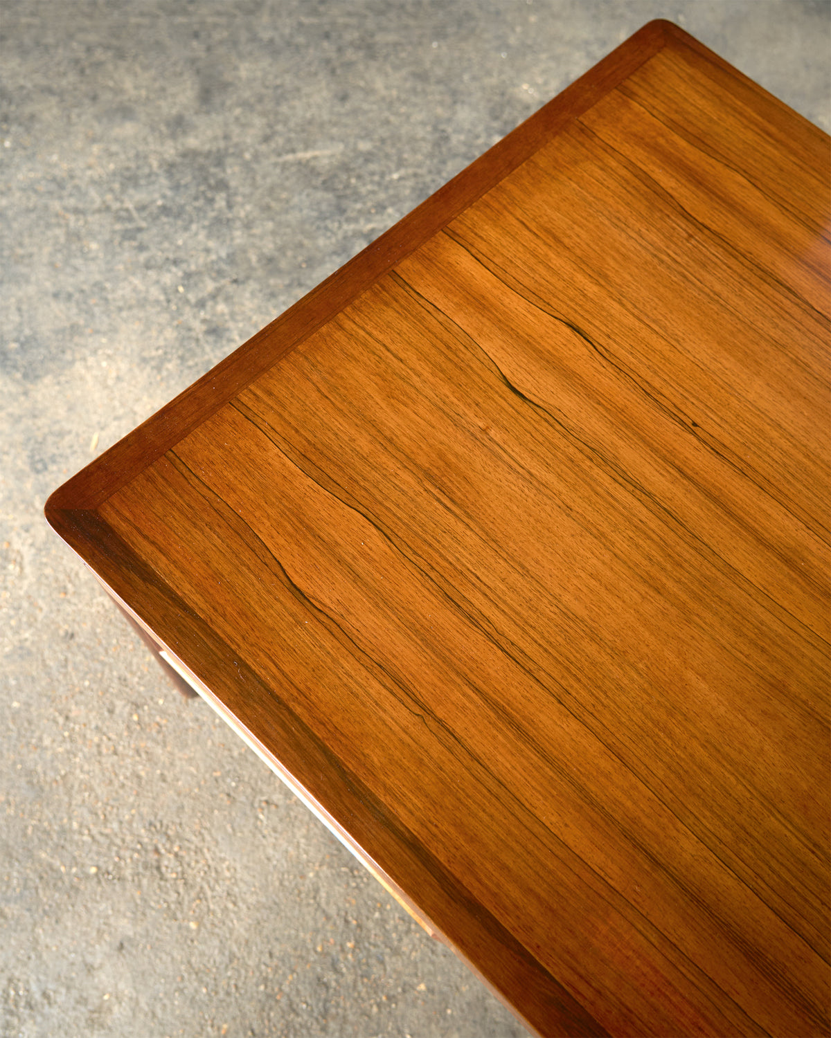 A generous Italian 1970's rosewood kneehole desk