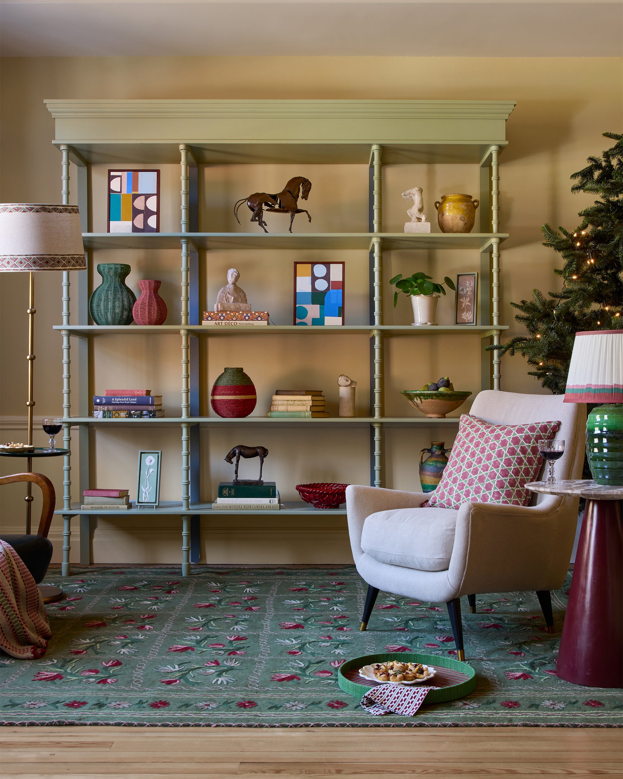 Green bookshelf, decorated with accessories for Christmas