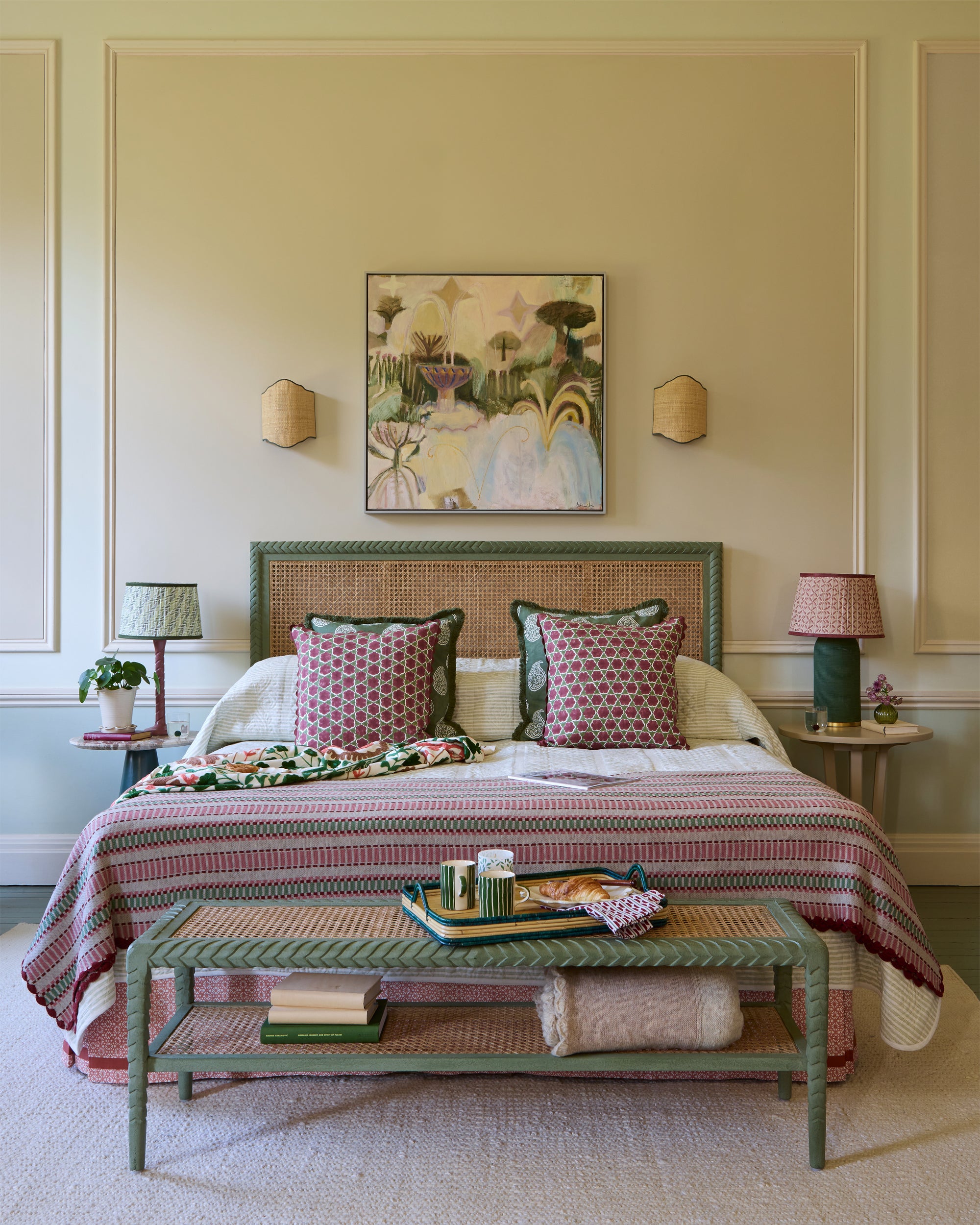 Decorative bedroom with a bed, coffee table, and wall art.
