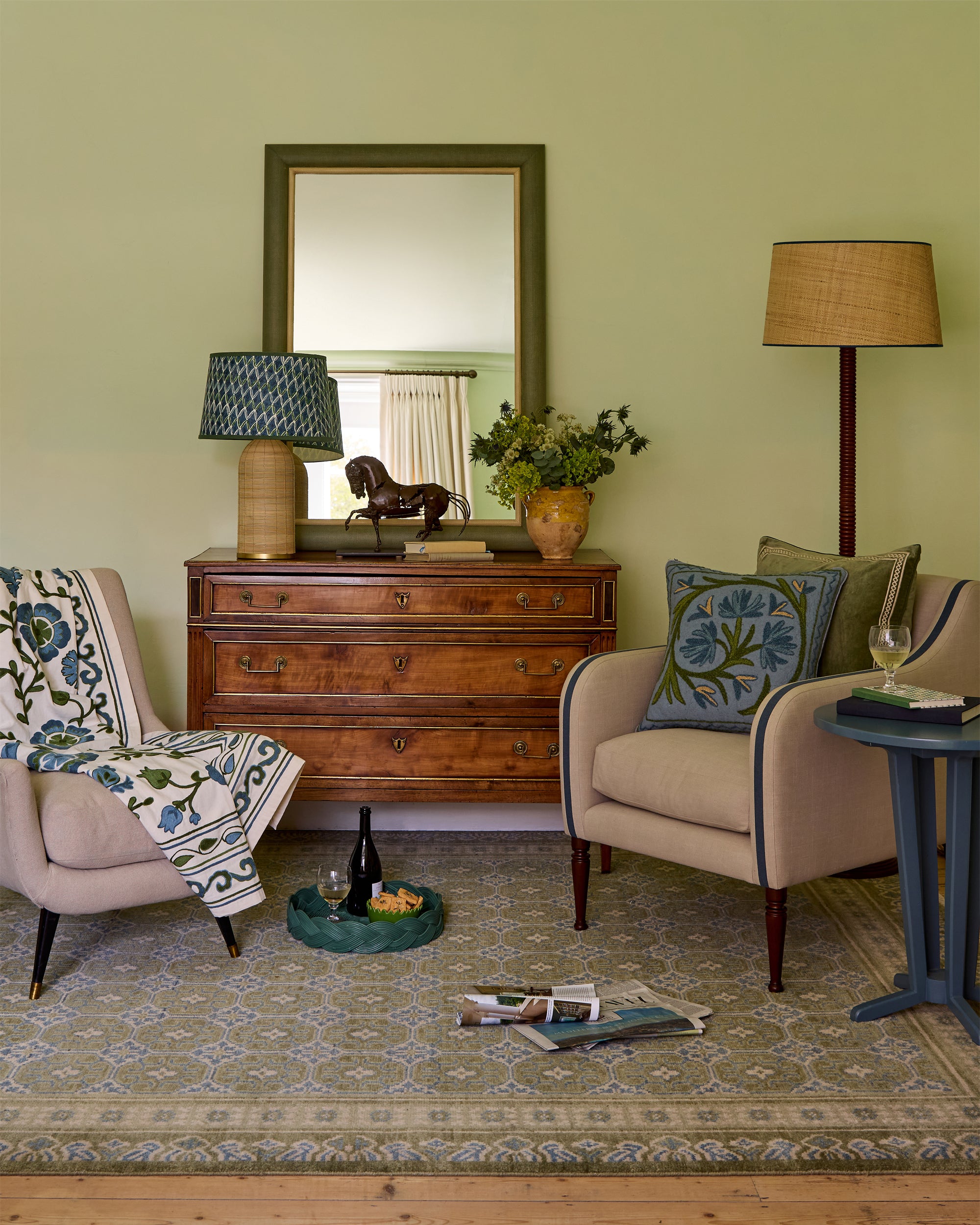 Sitting room with beige armchair, wooden dresser, and decorative items.