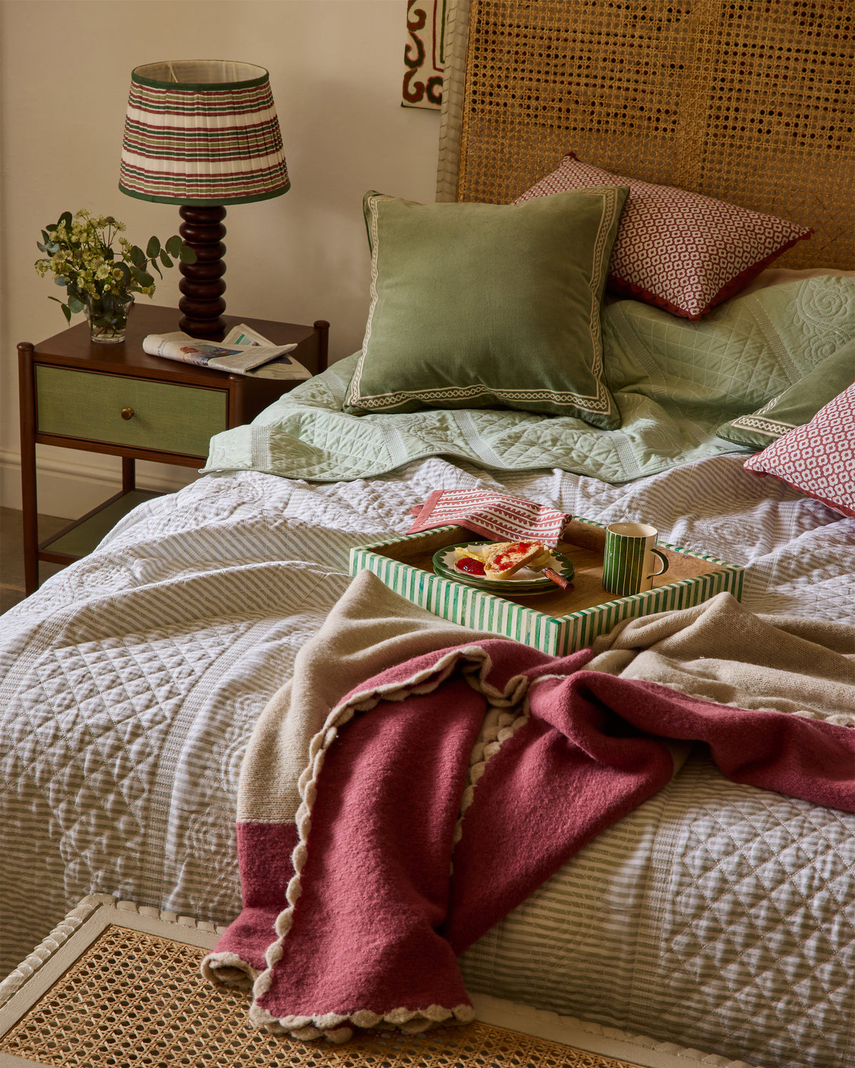 Cozy bedroom with a bed, nightstand, and decorative items.