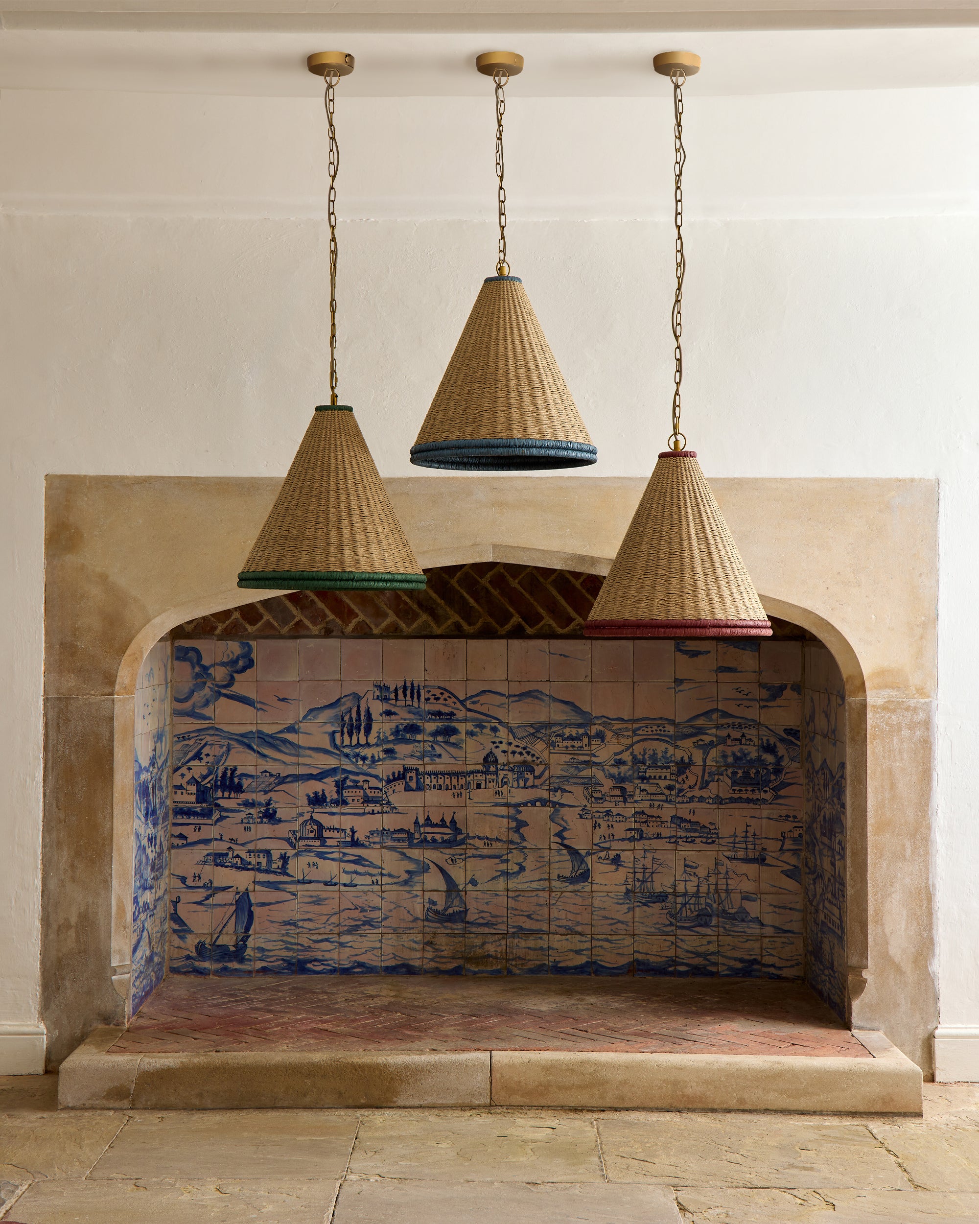 Decorative fireplace with tiled back and hanging wicker lamps.