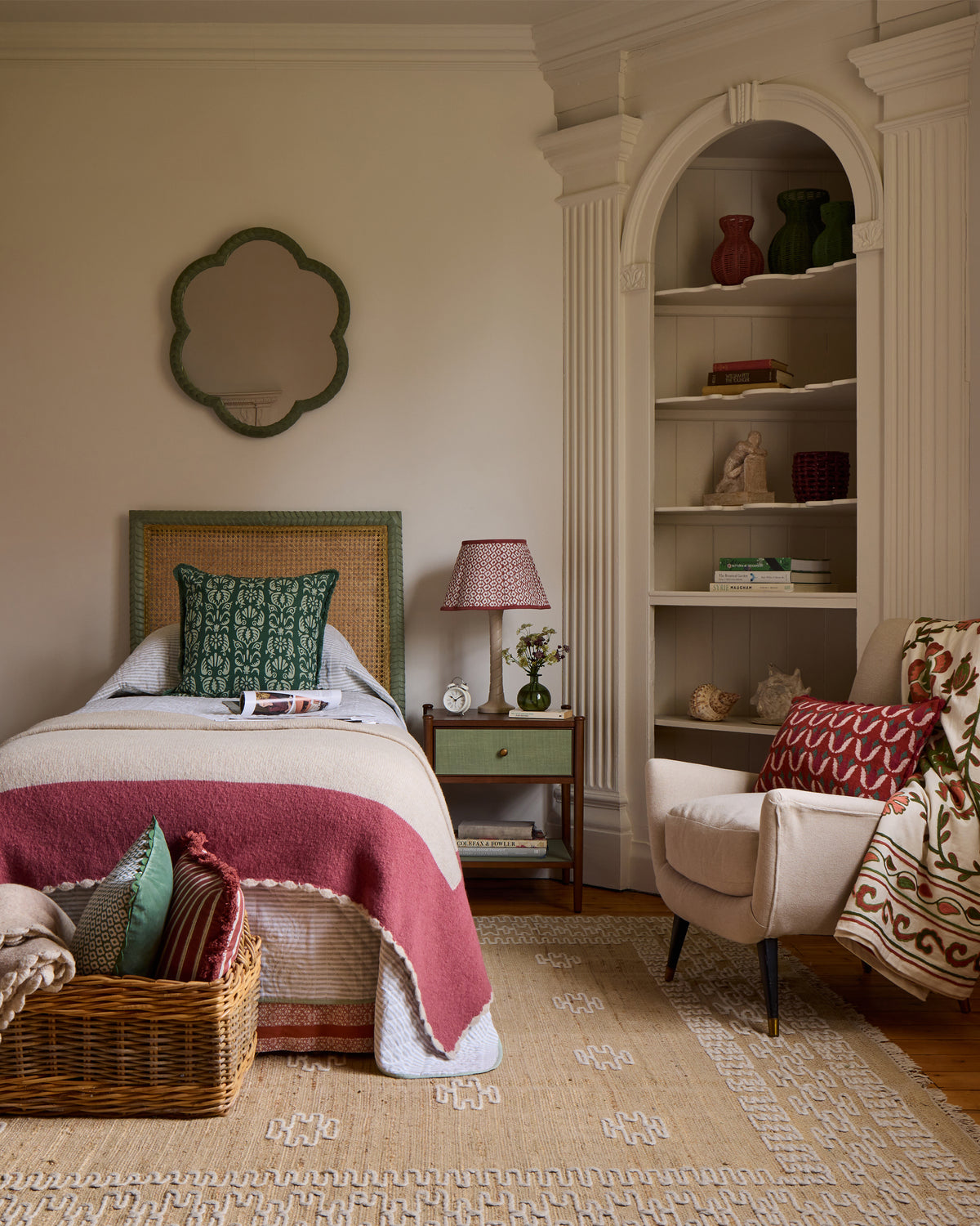 Cozy bedroom with a bed, chair, and bookshelf.