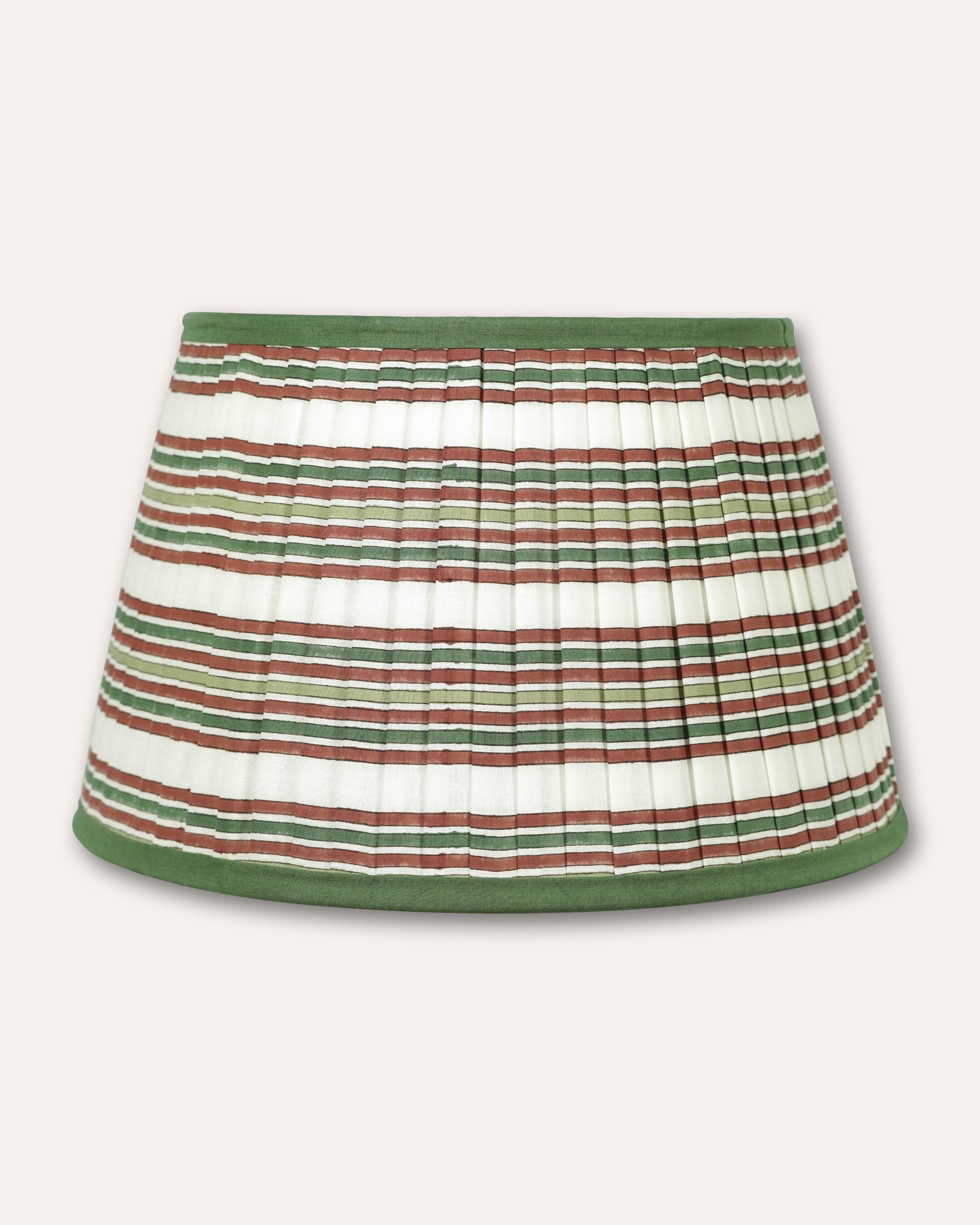 A pleated fabric lampshade with horizontal stripes in green, brown, and white, finished with solid green trim at the waistband and hem, shown against a light beige background.