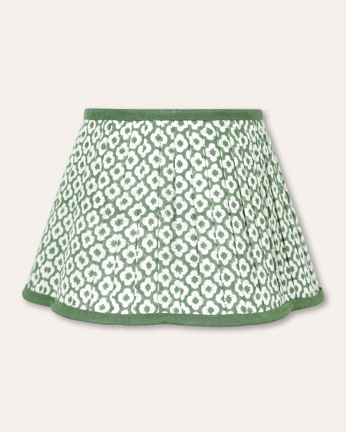 A green and white patterned pleated lampshade with a solid green hem, shown against a light beige background.