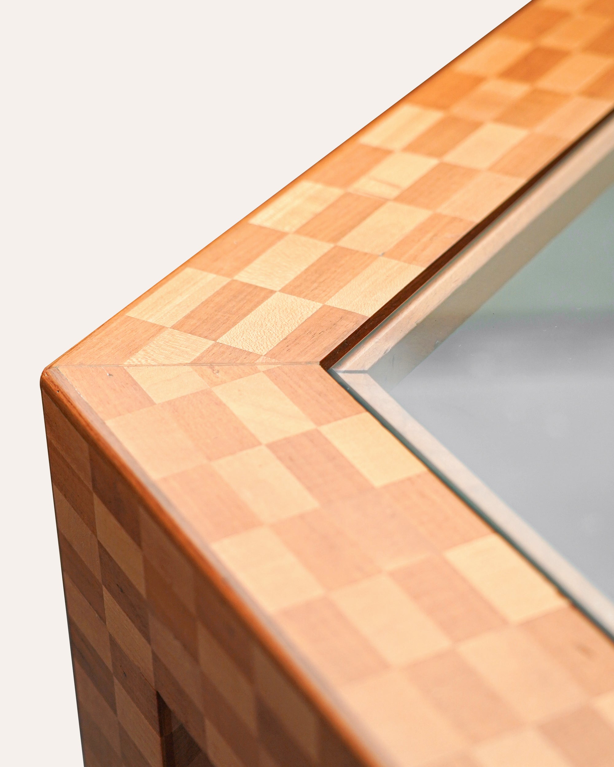 Close-up of a wooden surface with a checkered pattern on a white background