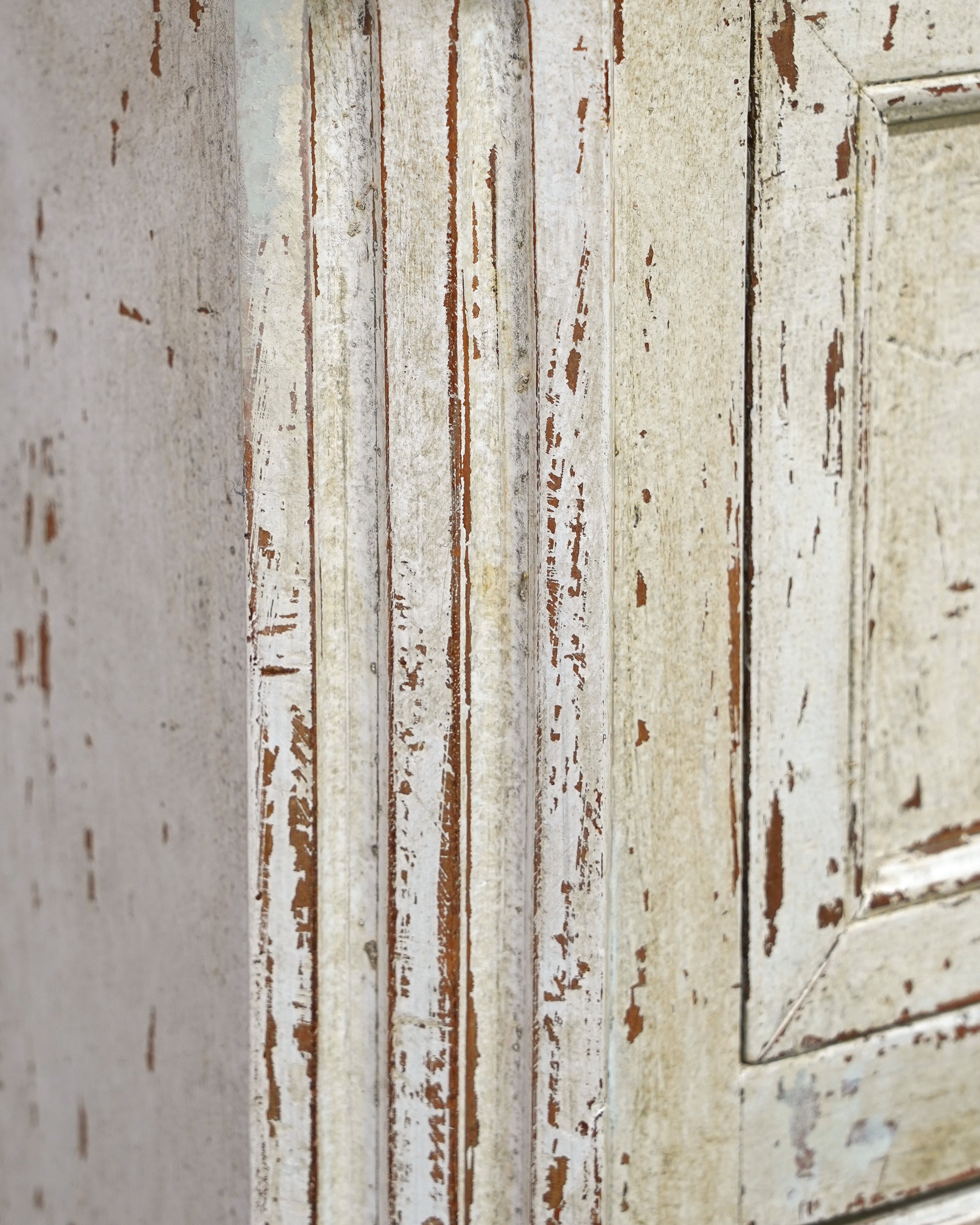Close-up of a weathered wooden door with peeling paint