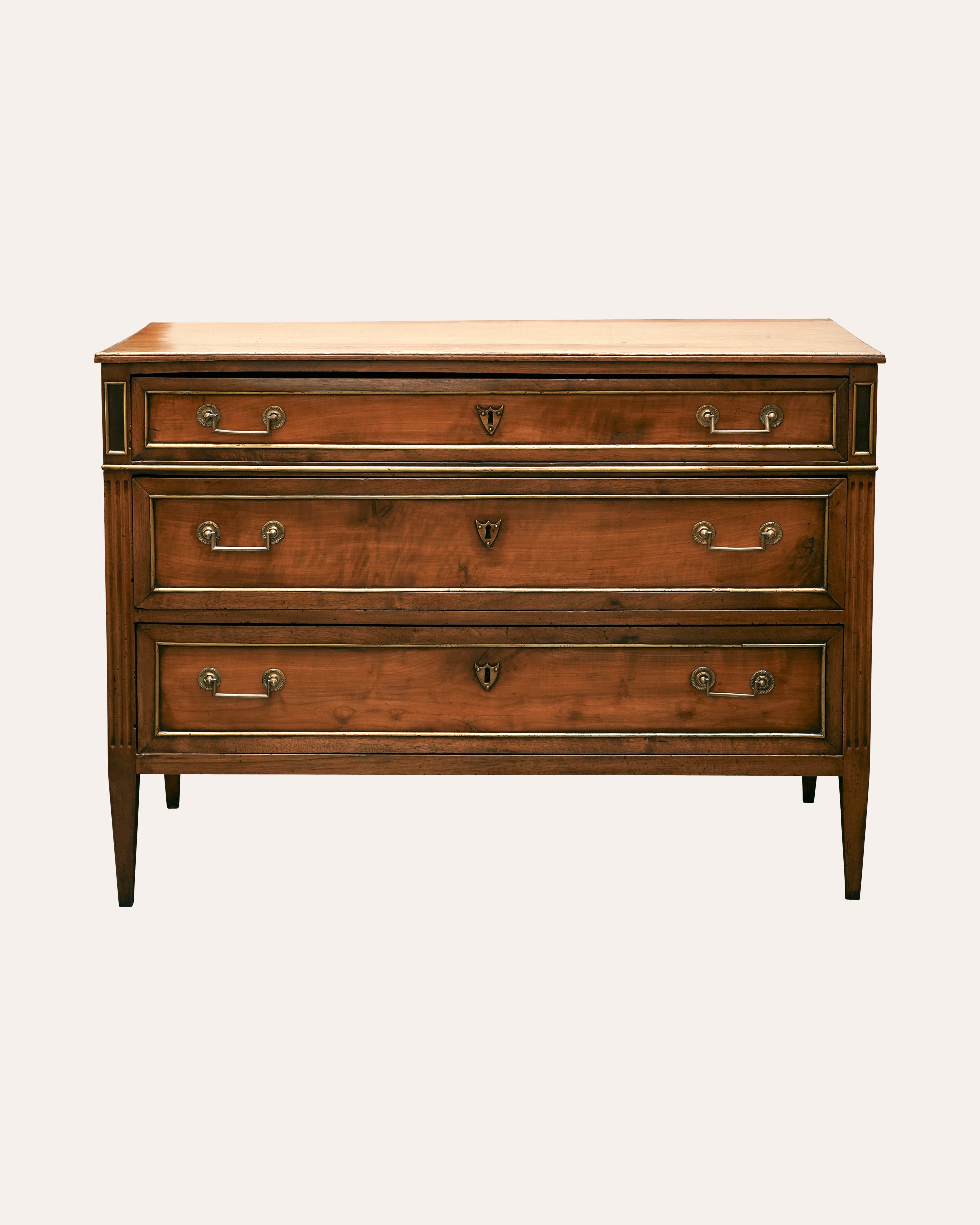 Wooden dresser with four drawers on a white background