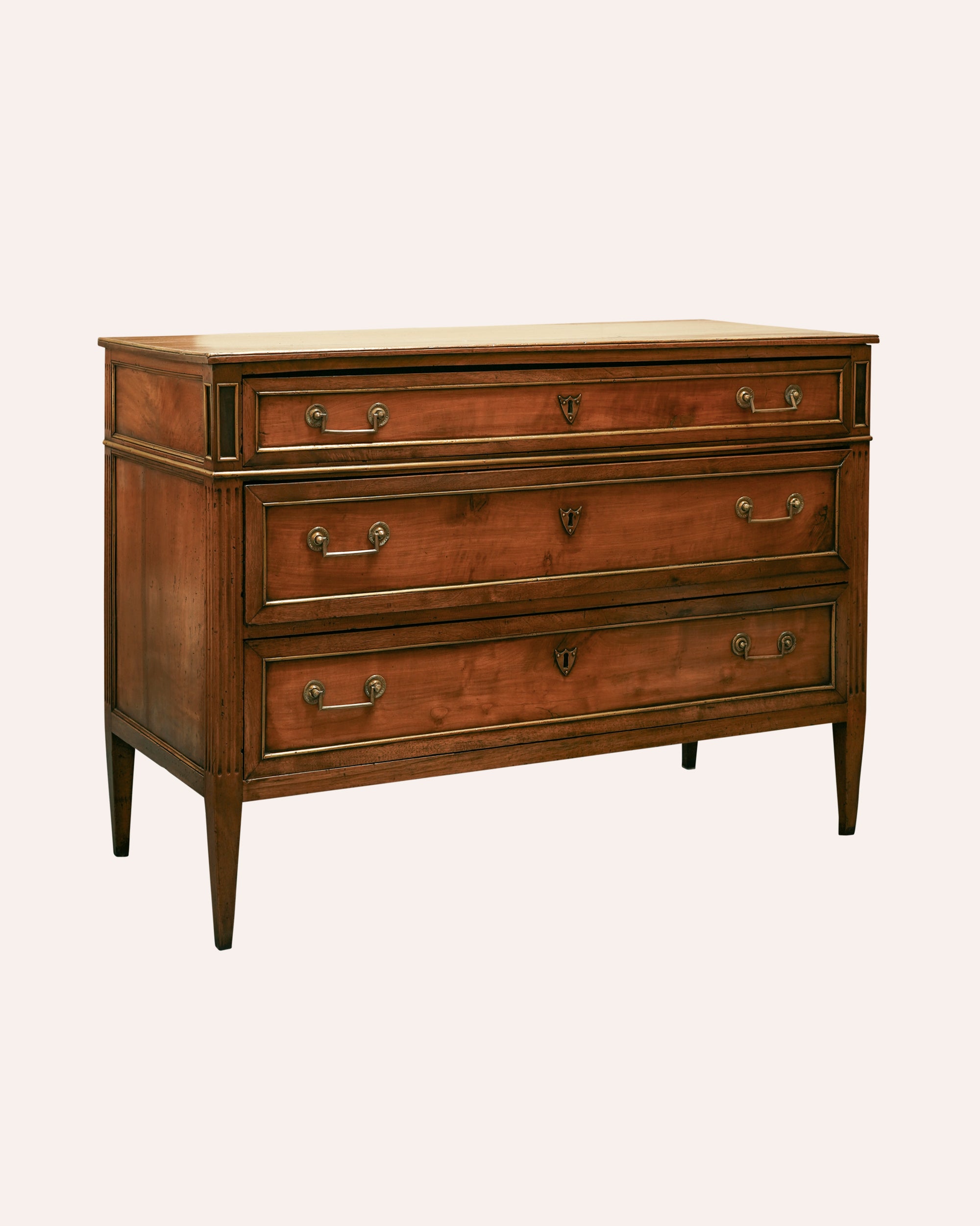 Wooden dresser with four drawers on a white background