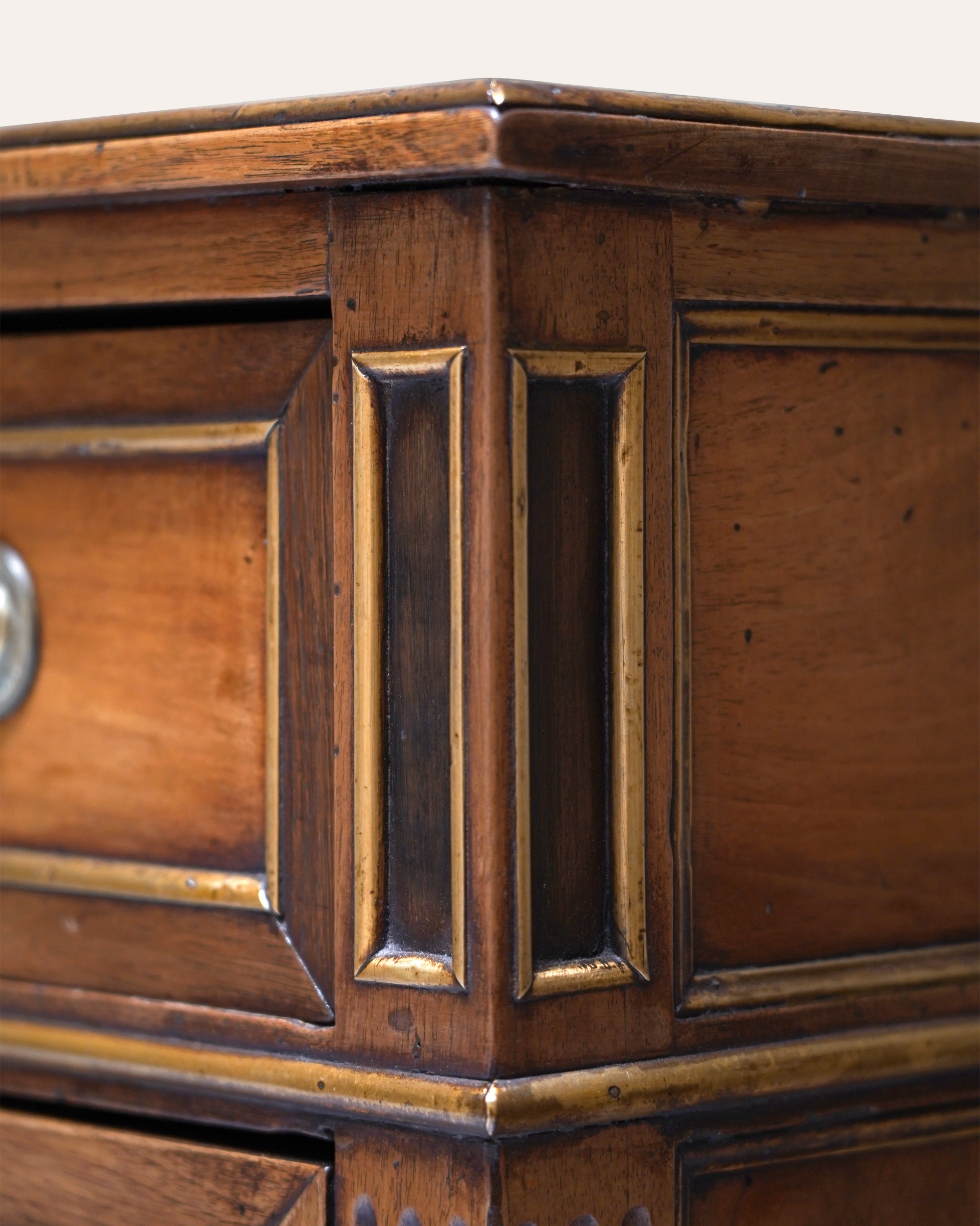Close-up of a wooden cabinet with intricate carvings and a knob.