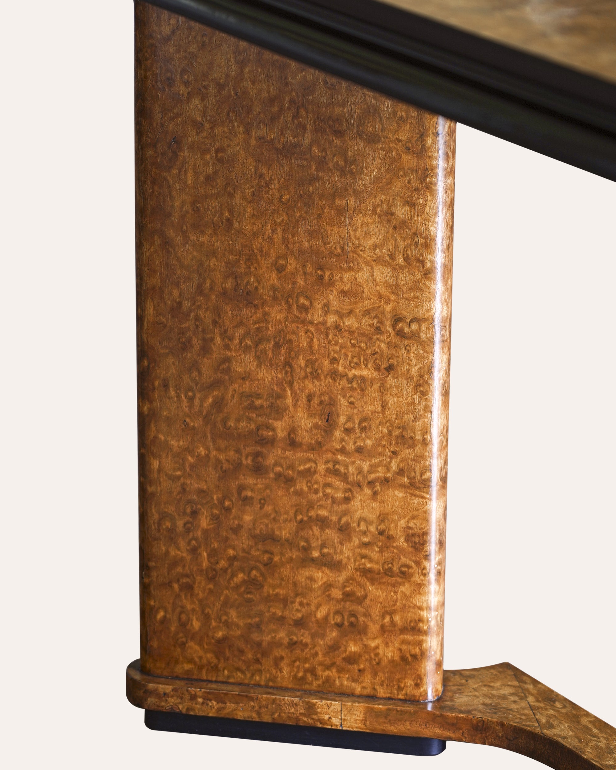 Close-up of a wooden desk with a focus on the grain and texture of the wood.
