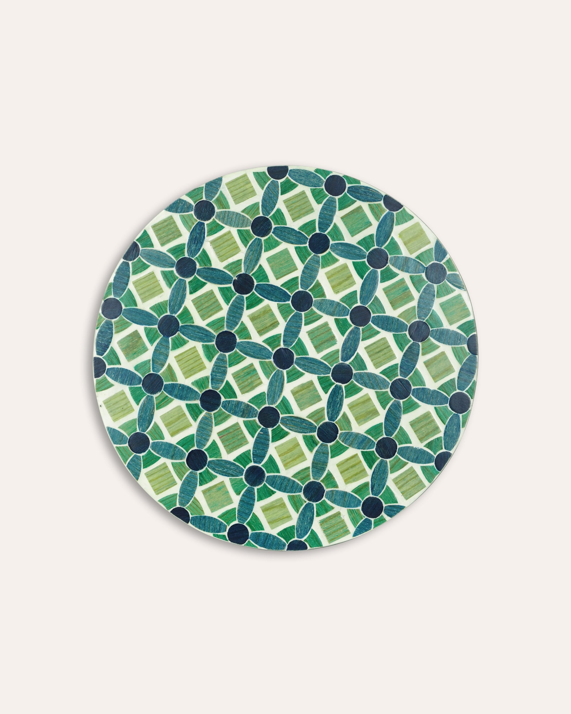 Round green and blue patterned placemat on a white background