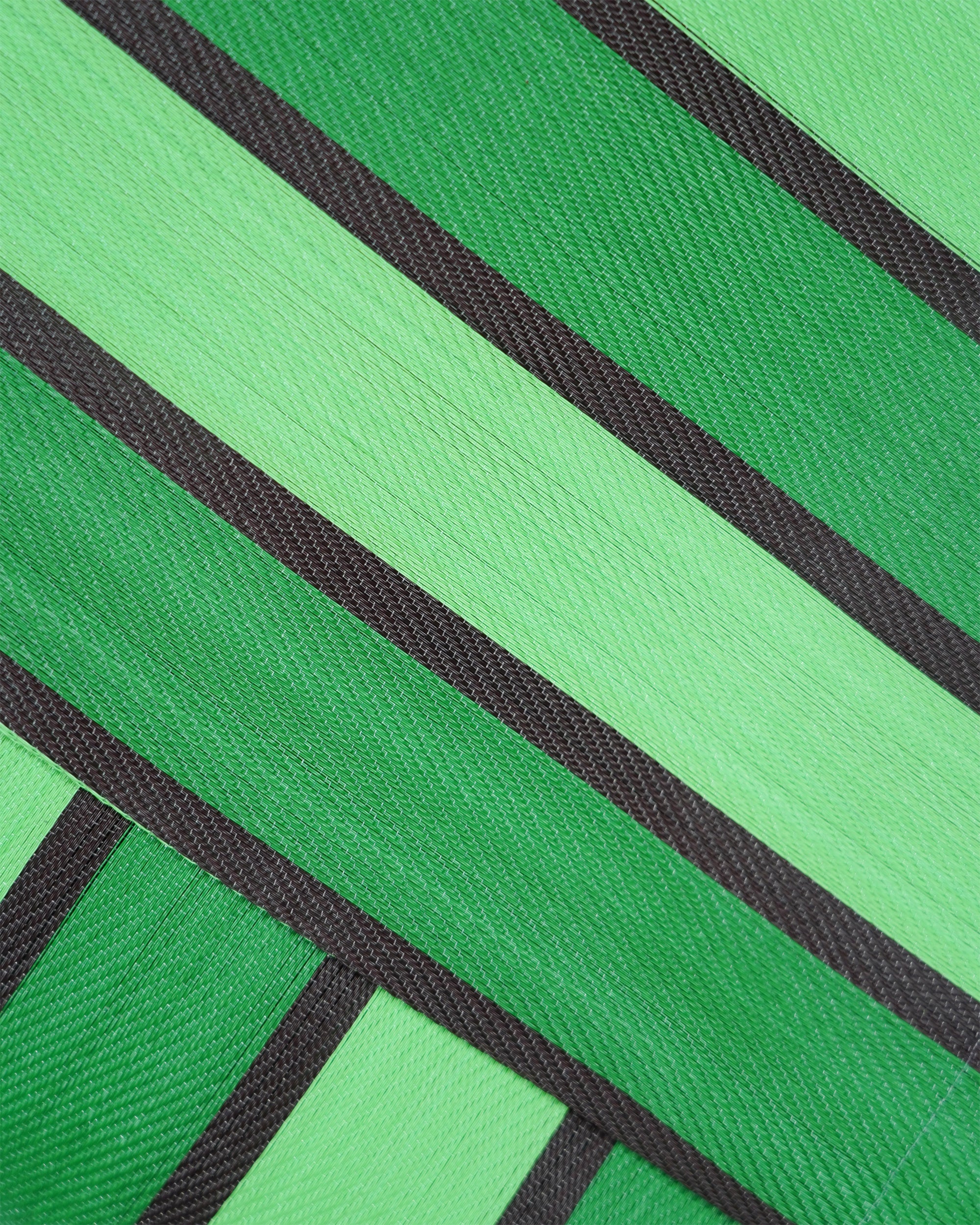 Close-up of green and black striped fabric texture
