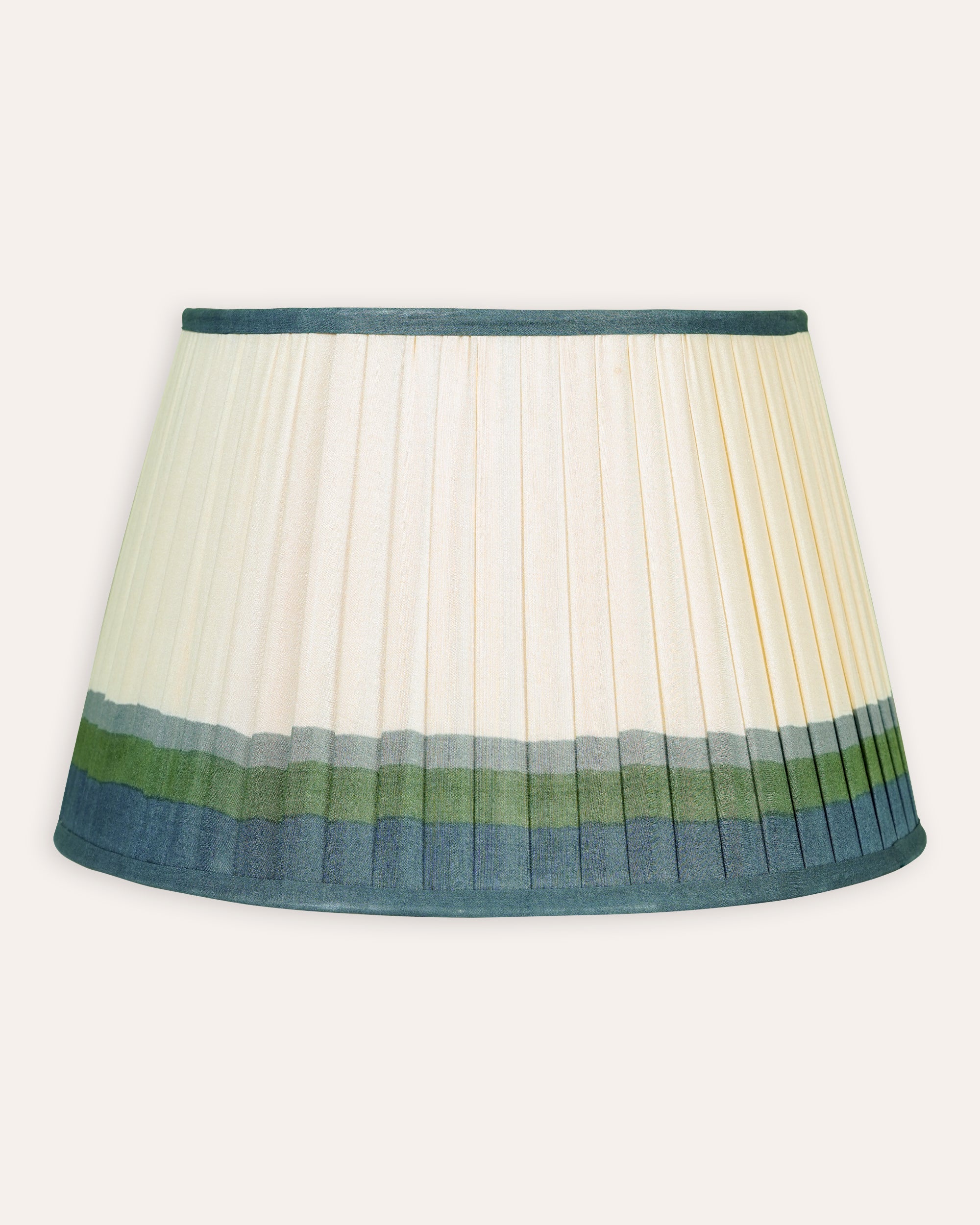 Lampshade with pleated design and green and blue bands on a white background