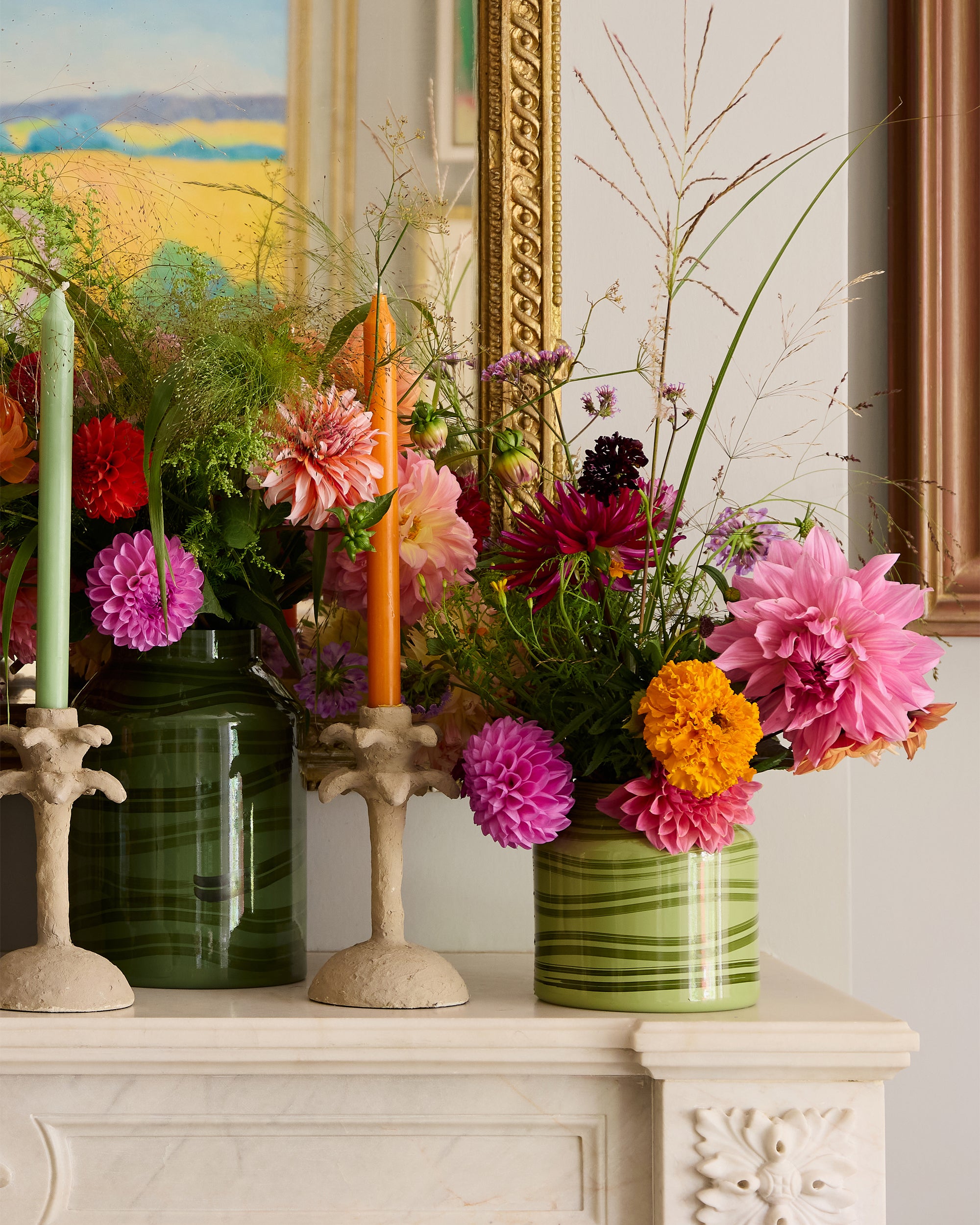 Fireplace styled with green Maypole vases and taupe palm tree candlesticks