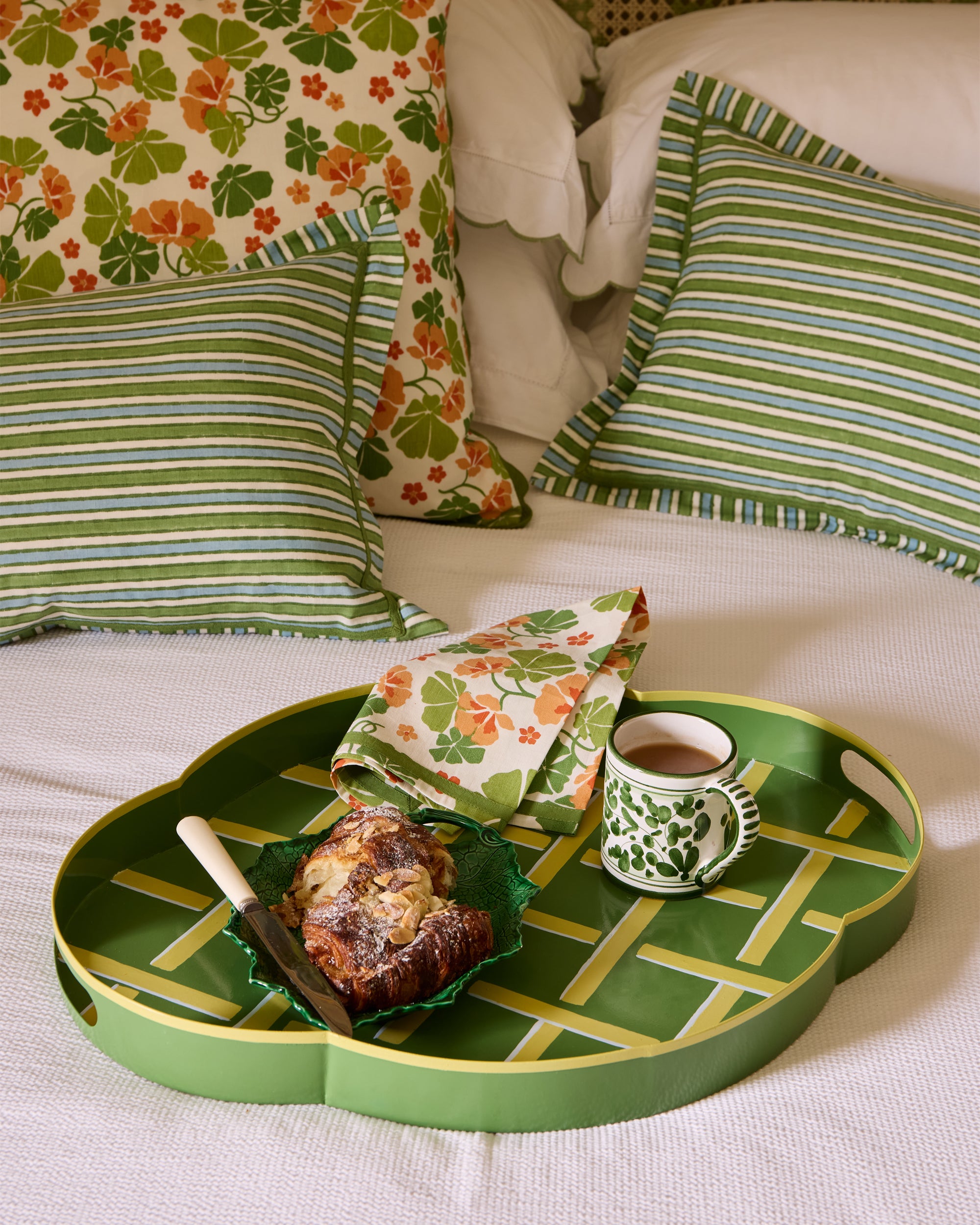 Relaxed bed featuring the Tole trellis tray and Nasturtium napkin with a croissant and cup of tea