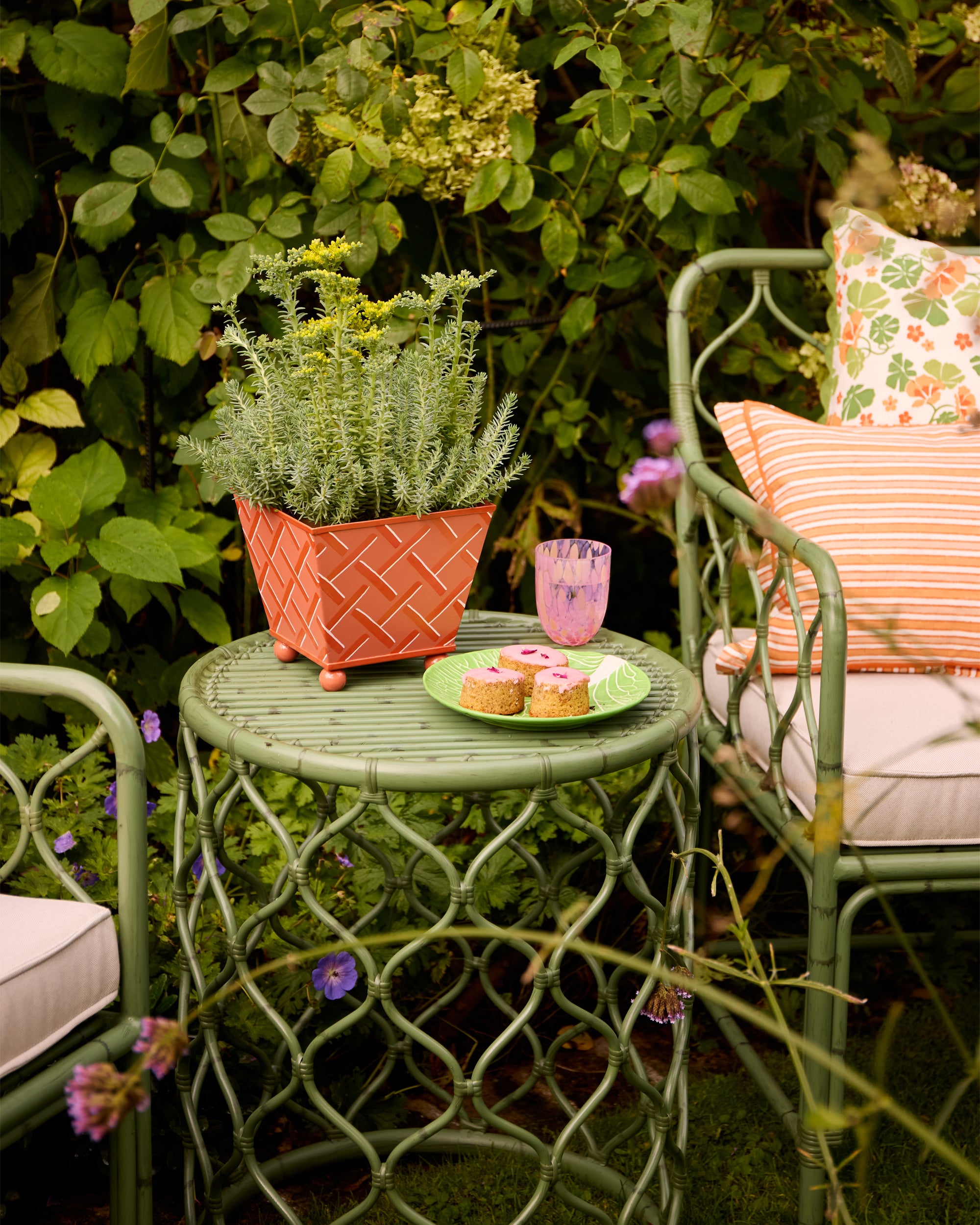 The orange Tole planter styled with the Curato side table