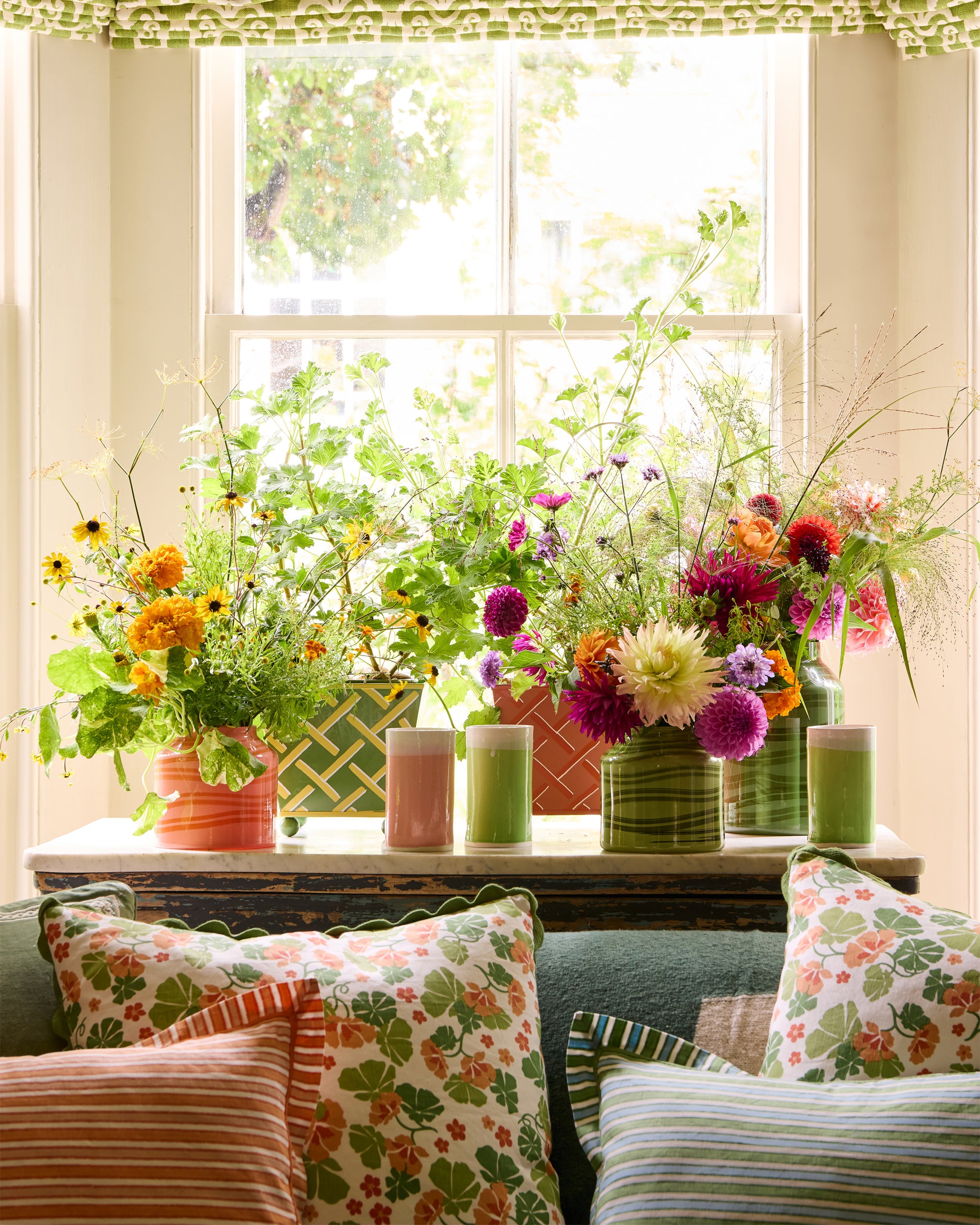 Beautiful arrangement of summer florals in the maypole vases, green and orange tole planters