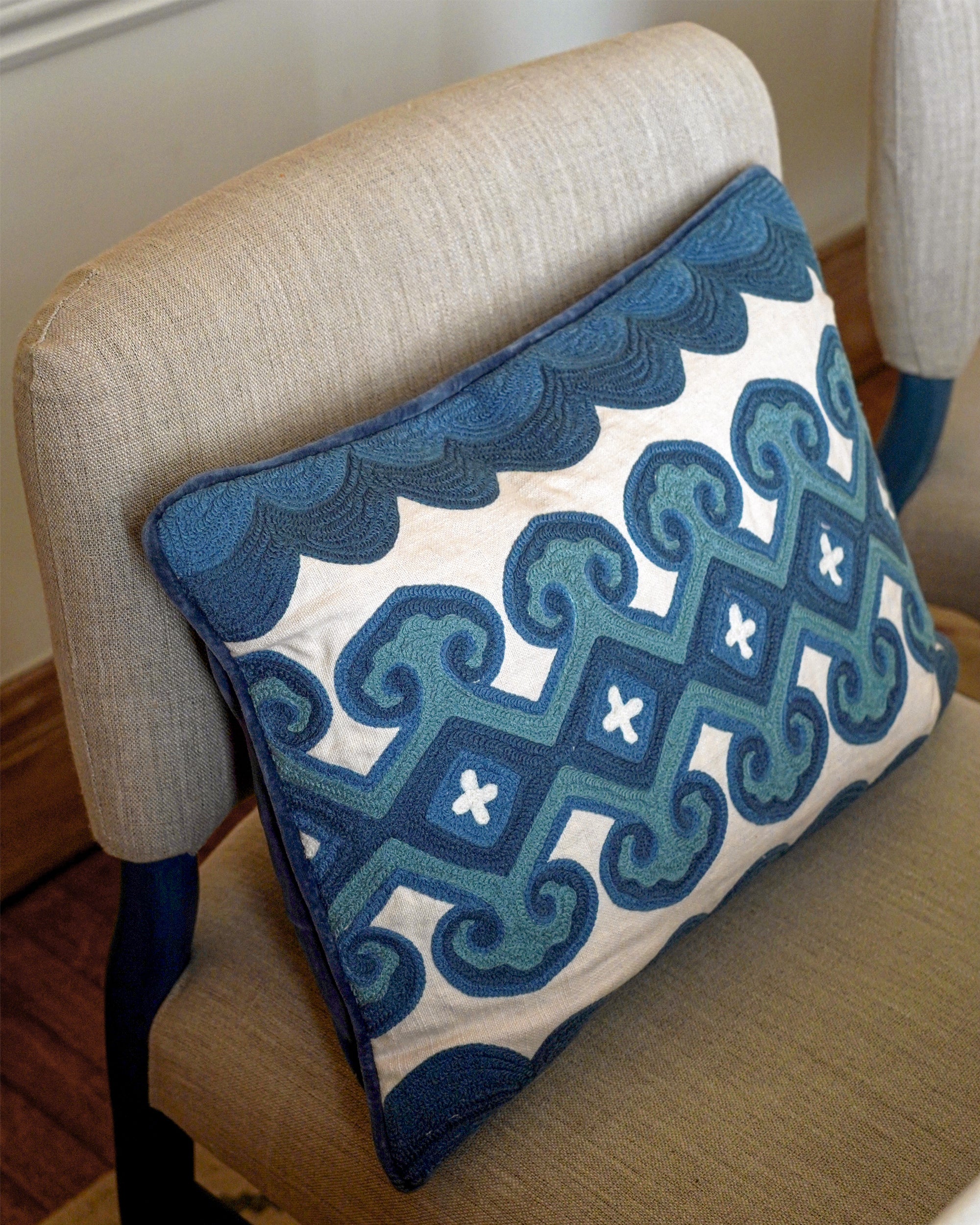 Decorative pillow with blue and white pattern on a chair