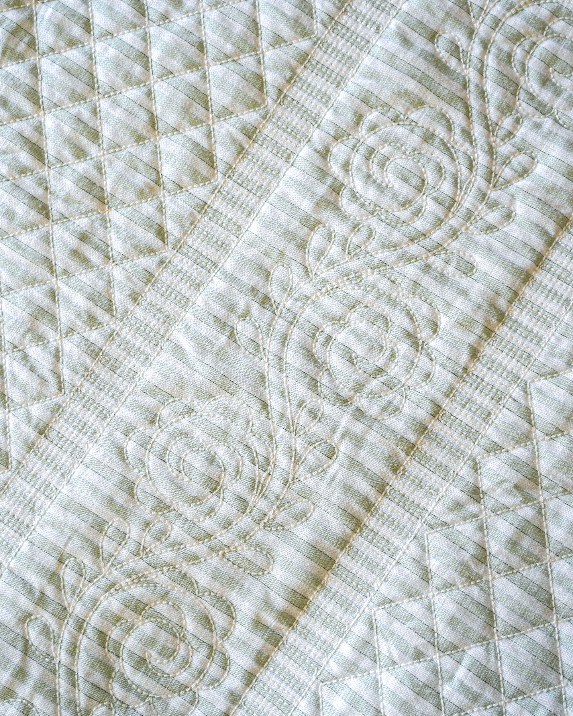 Close-up of a quilt with intricate stitching pattern