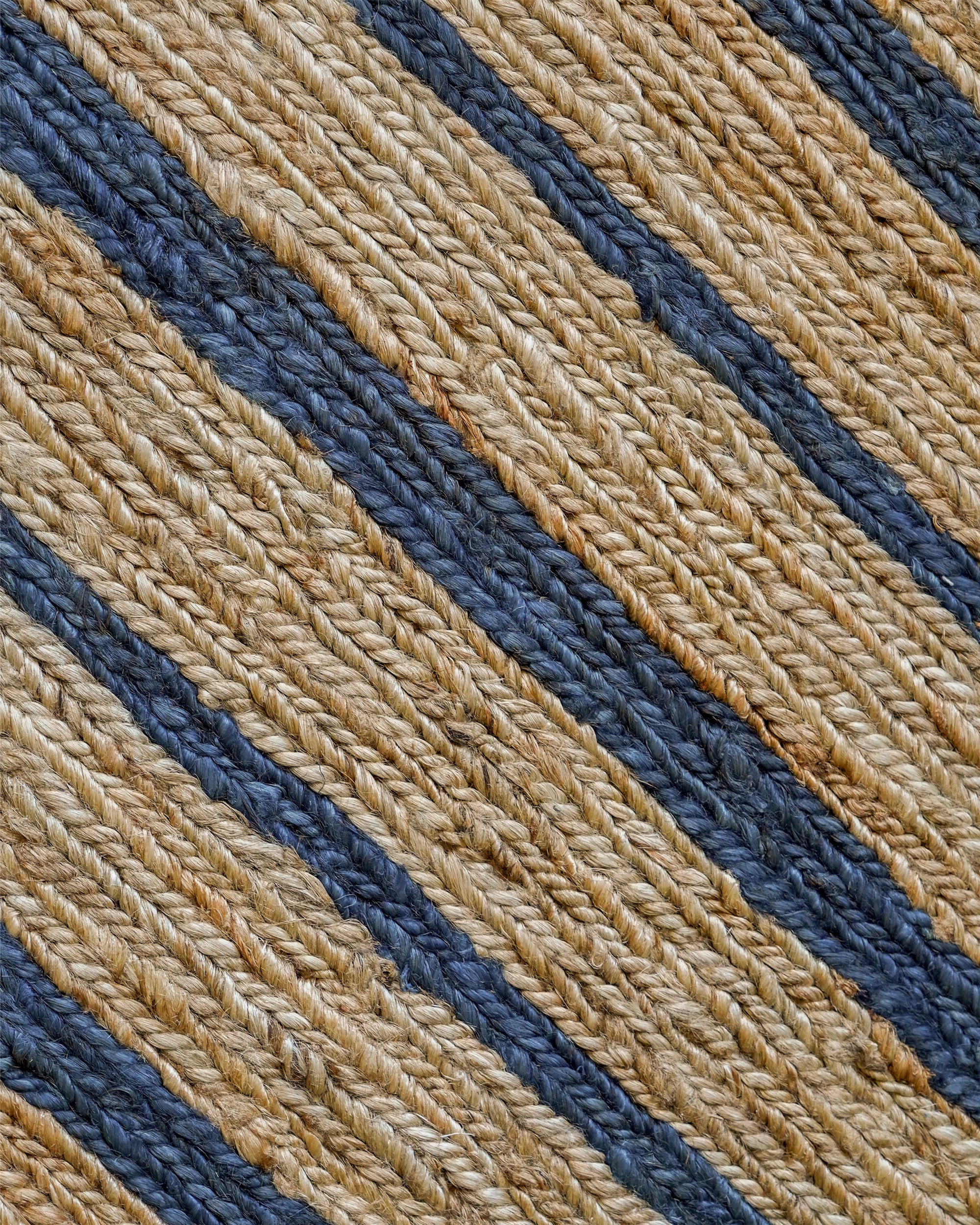 Close-up detail image of the blue striped jute rug