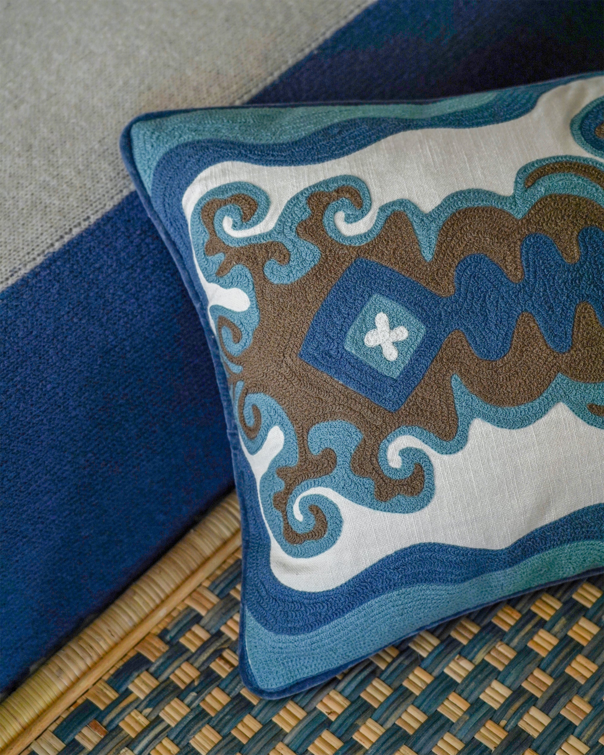 Decorative cushion with intricate patterns on a textured surface