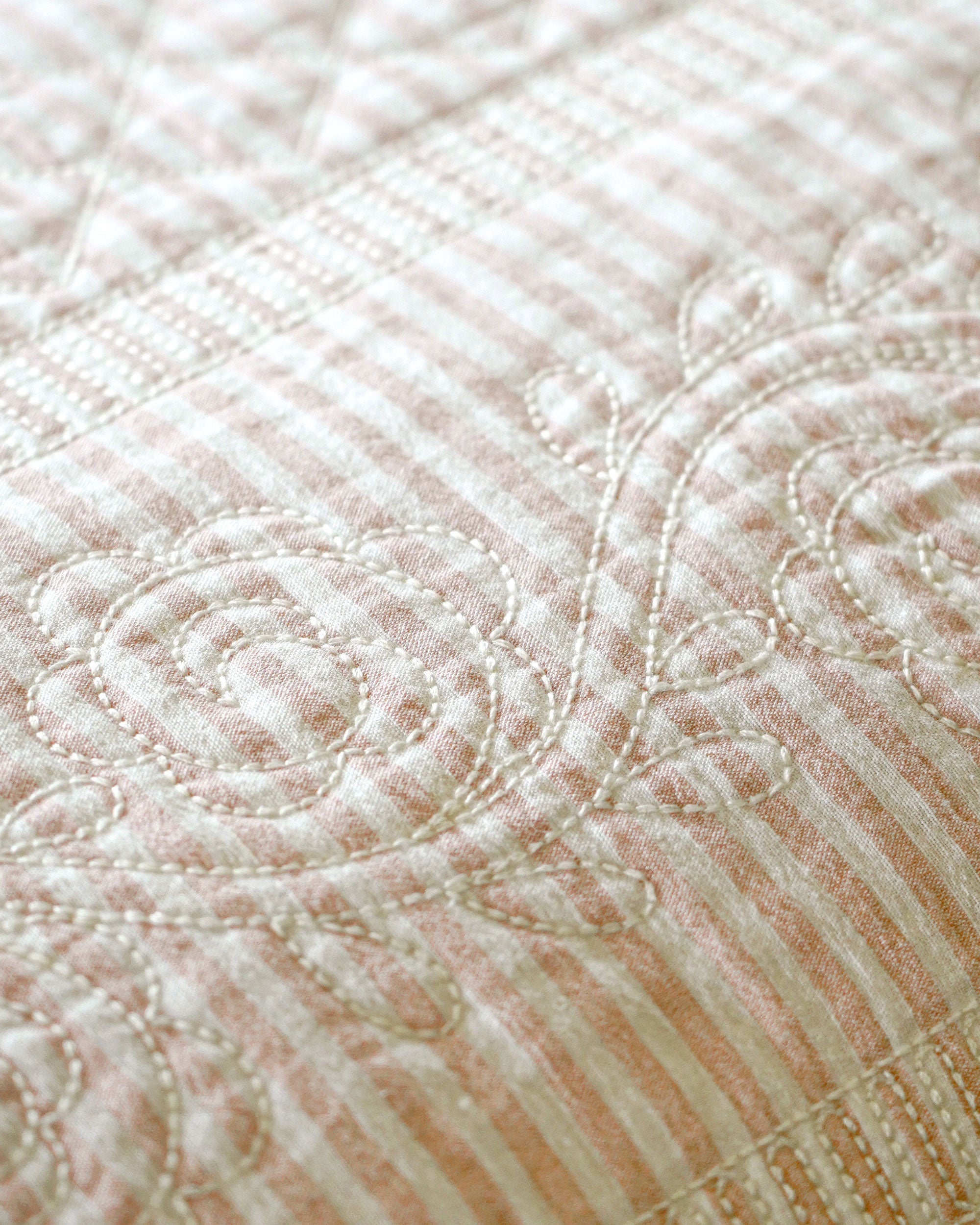 Close-up of a quilt with intricate stitching pattern