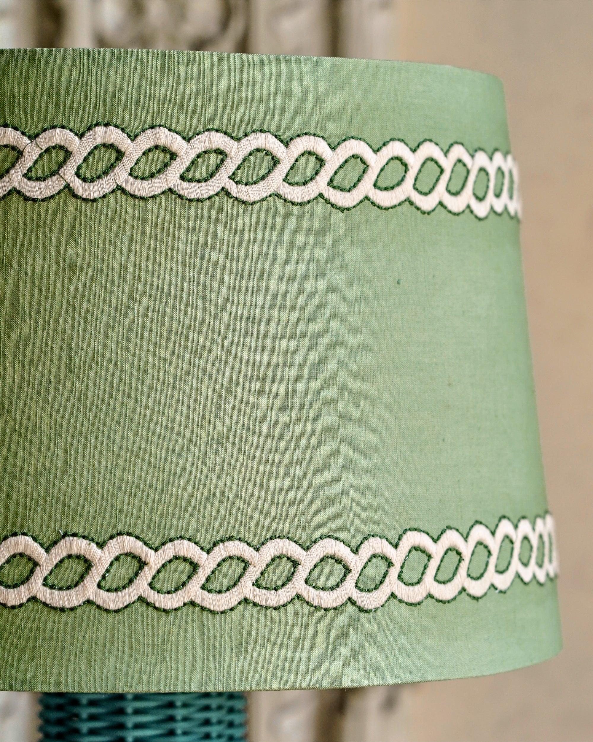 Green lampshade with white lace trim