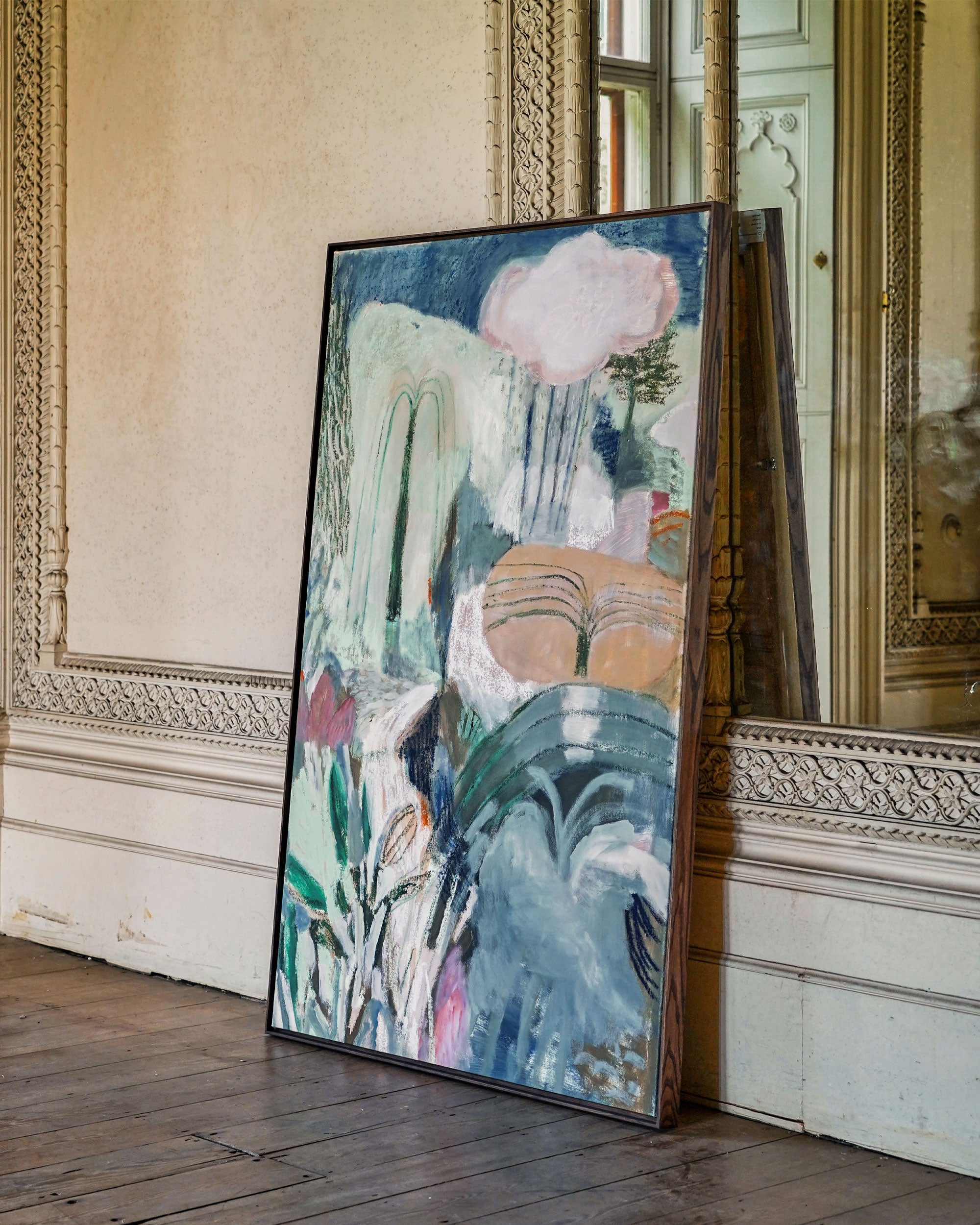 Abstract painting leaning against a wall in an elegant room with wooden floor and ornate decor.