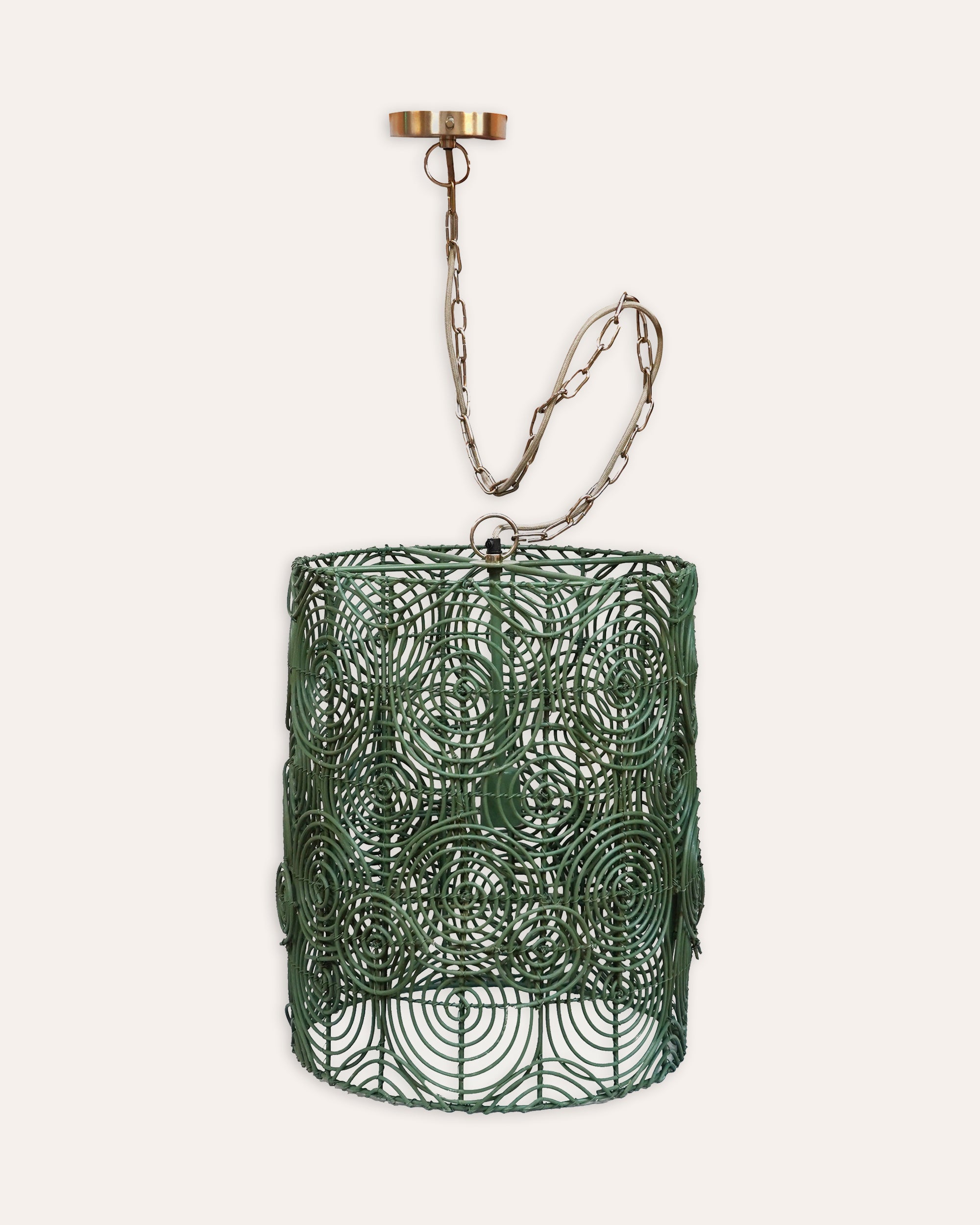 Decorative green circular pendant shade with a chain on a white background