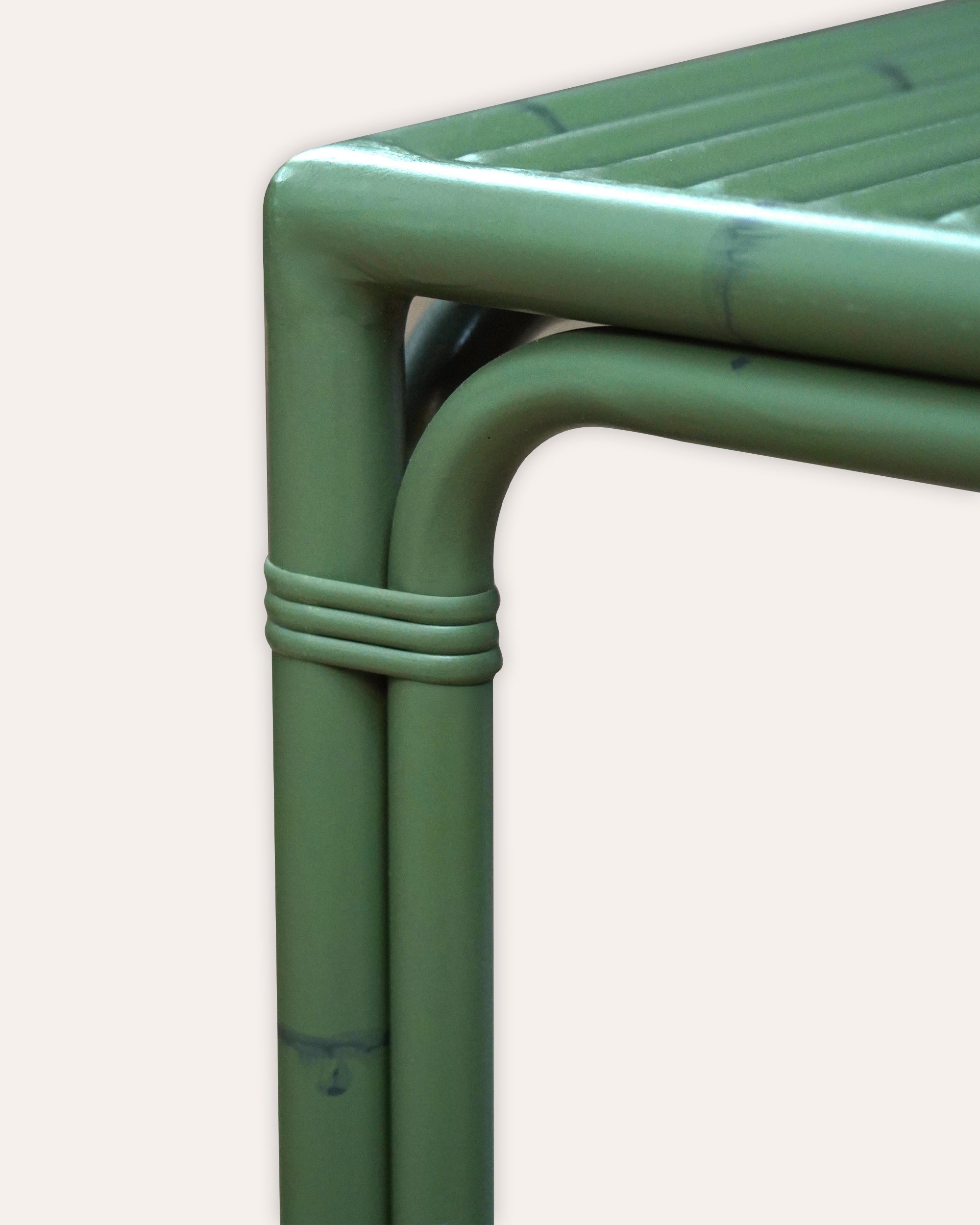 Green aluminium dining table frame on a white background
