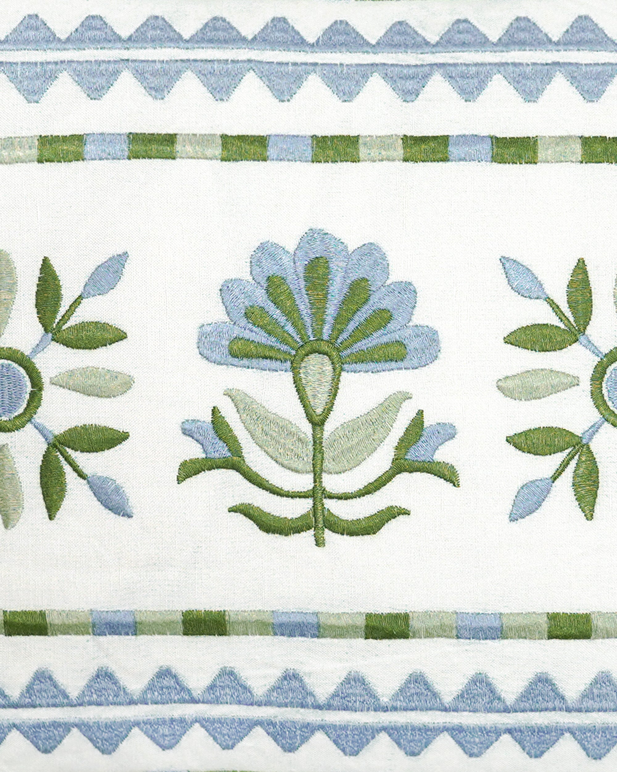 Close up detail image of the blue and green sancti embroidered rectangular spring summer cushion