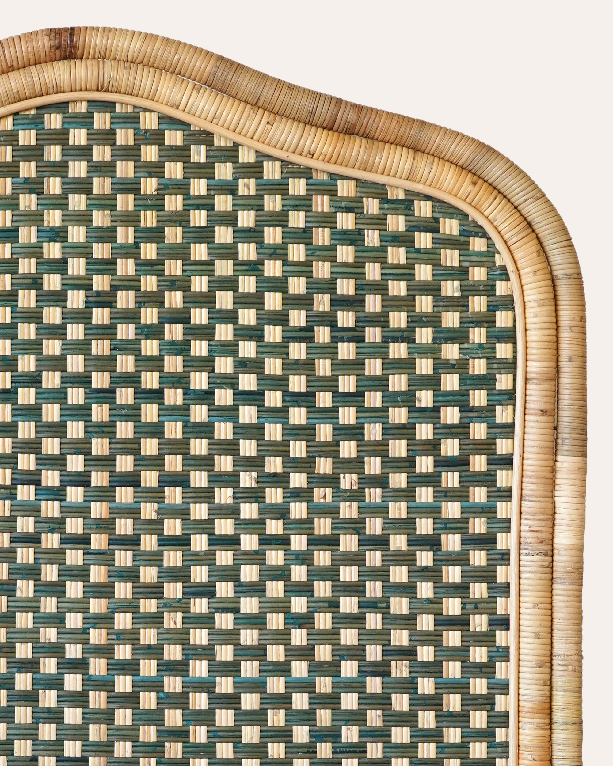 Close up detail of the woven pattern on the single green rattan headboard