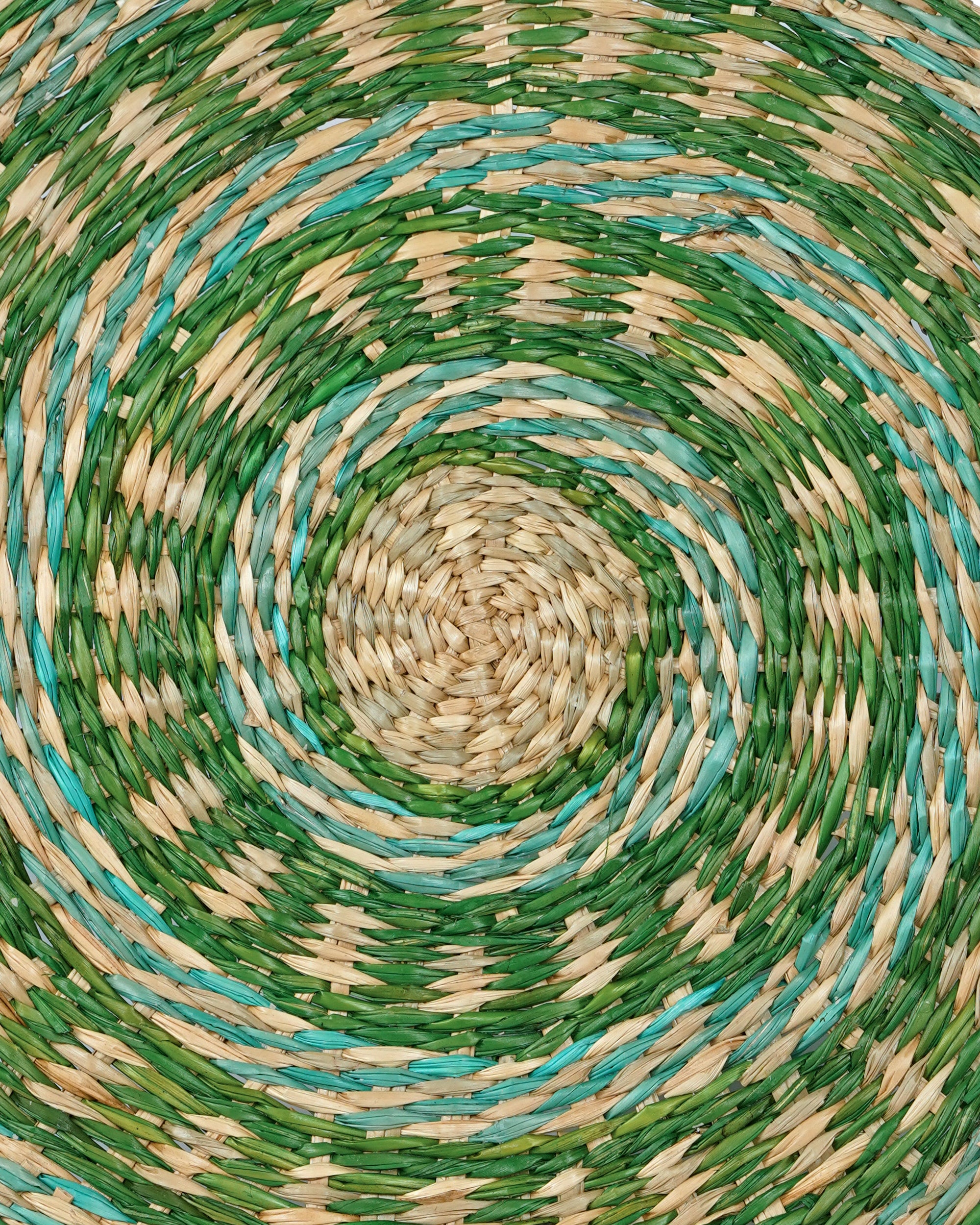 Close-up of a woven placemat with green and beige colours.