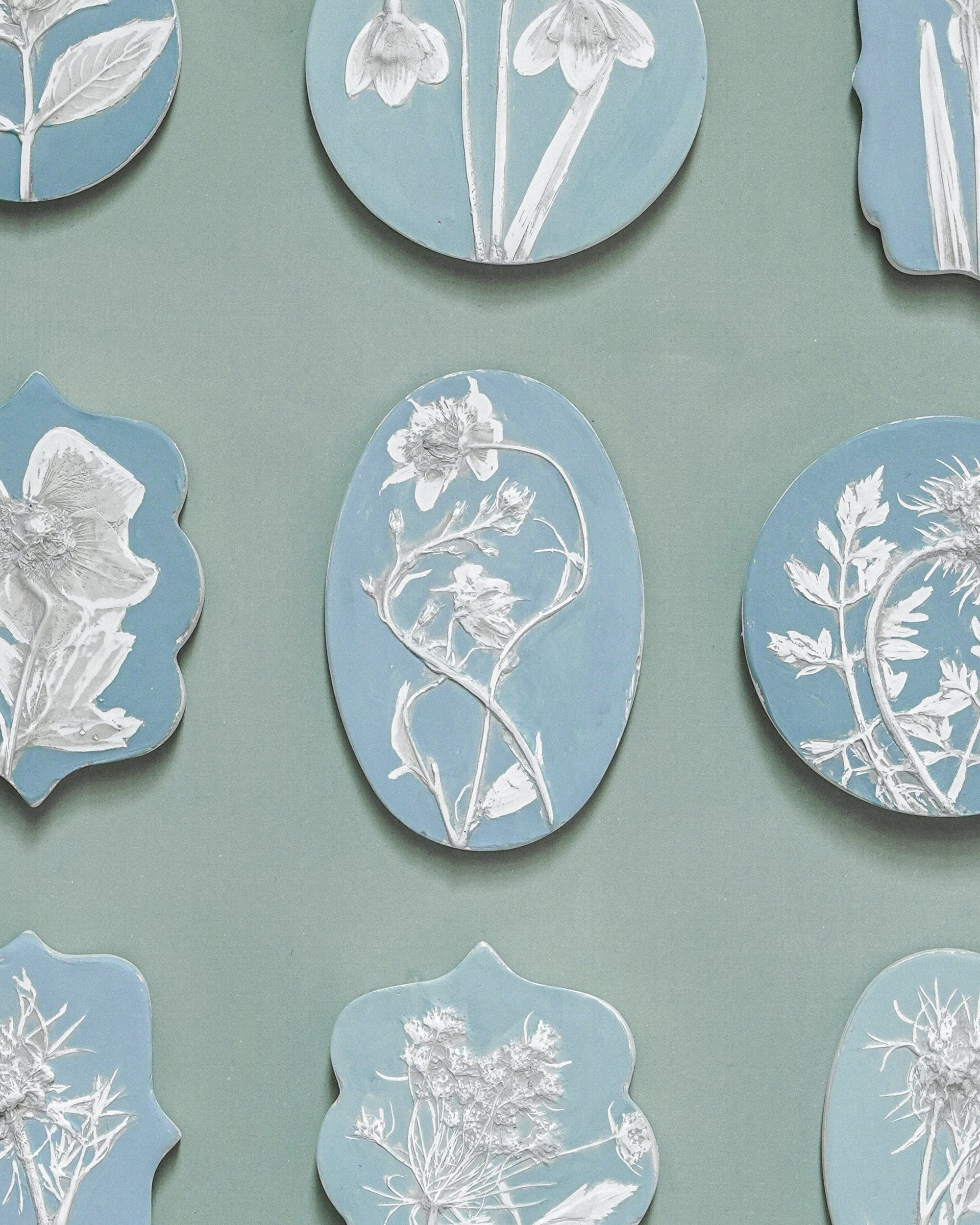 Decorative wall art with floral designs on a green background