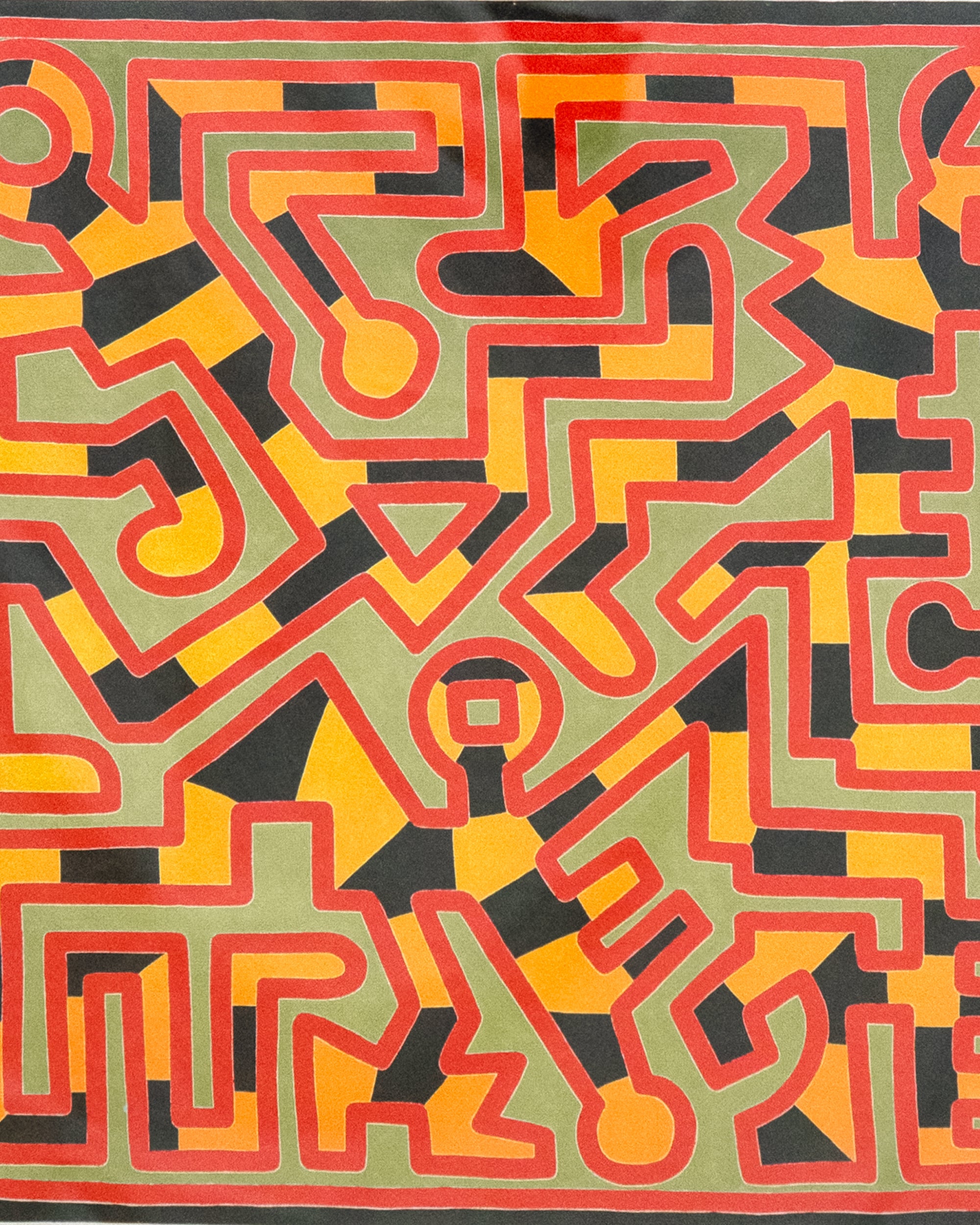 Colorful geometric pattern with red, yellow, and black on a green background