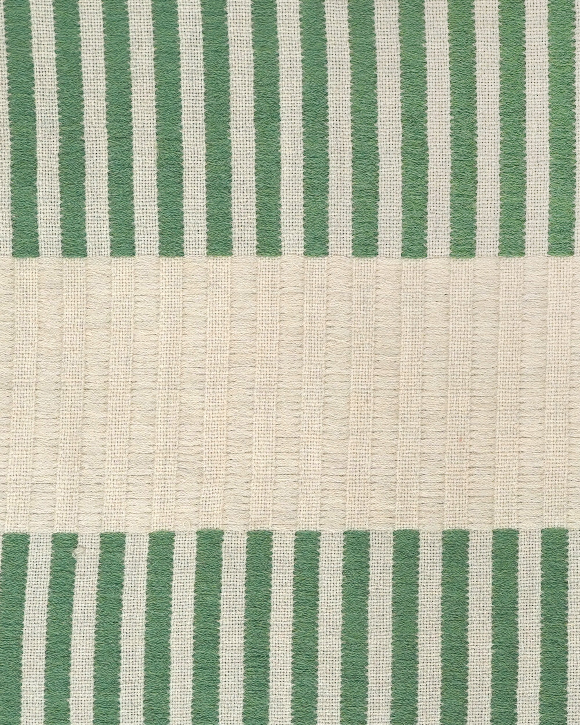 Close up detail of the green and taupe striped Dopatti throw
