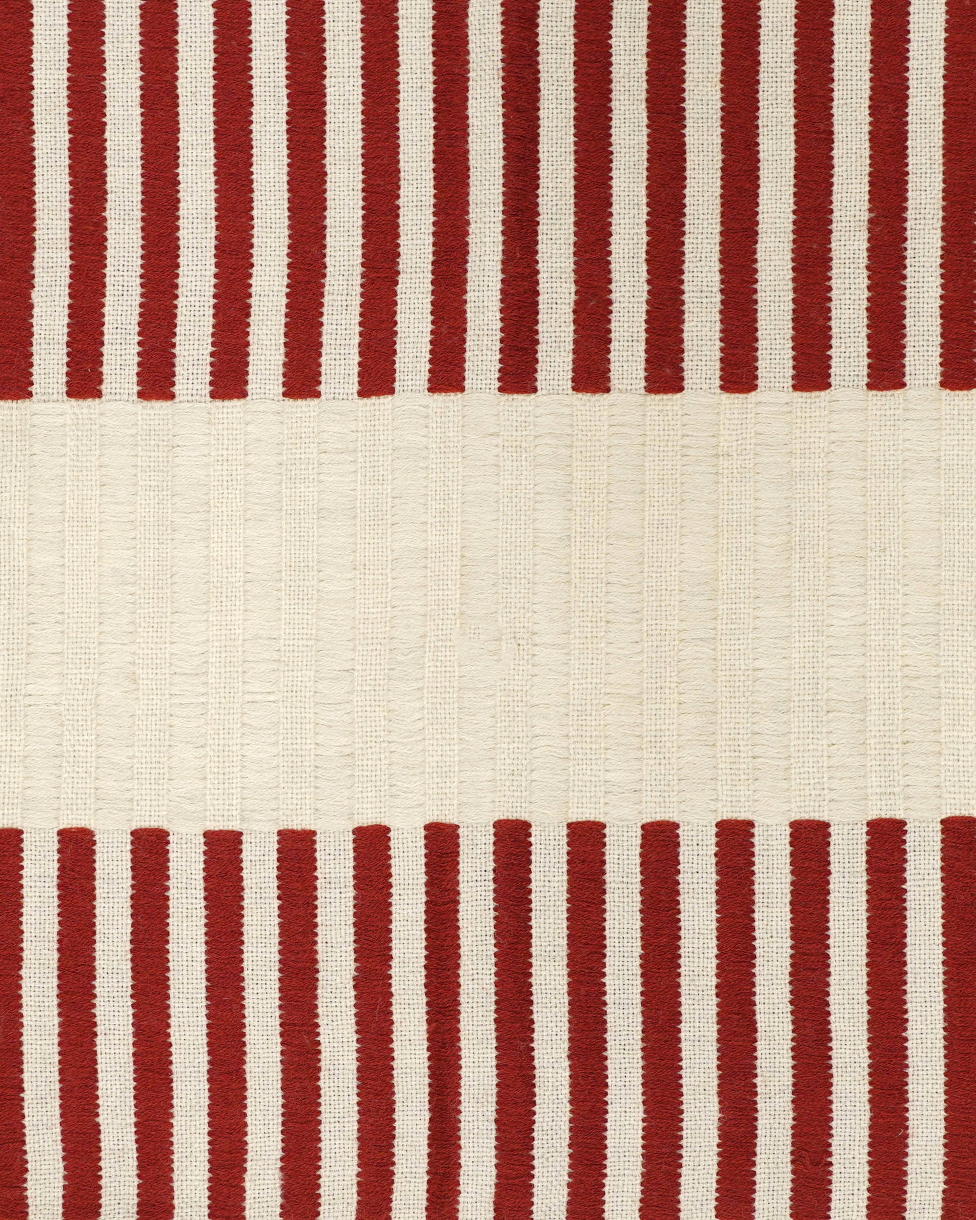 Close up detail of the red and taupe stripped Dopatti throw