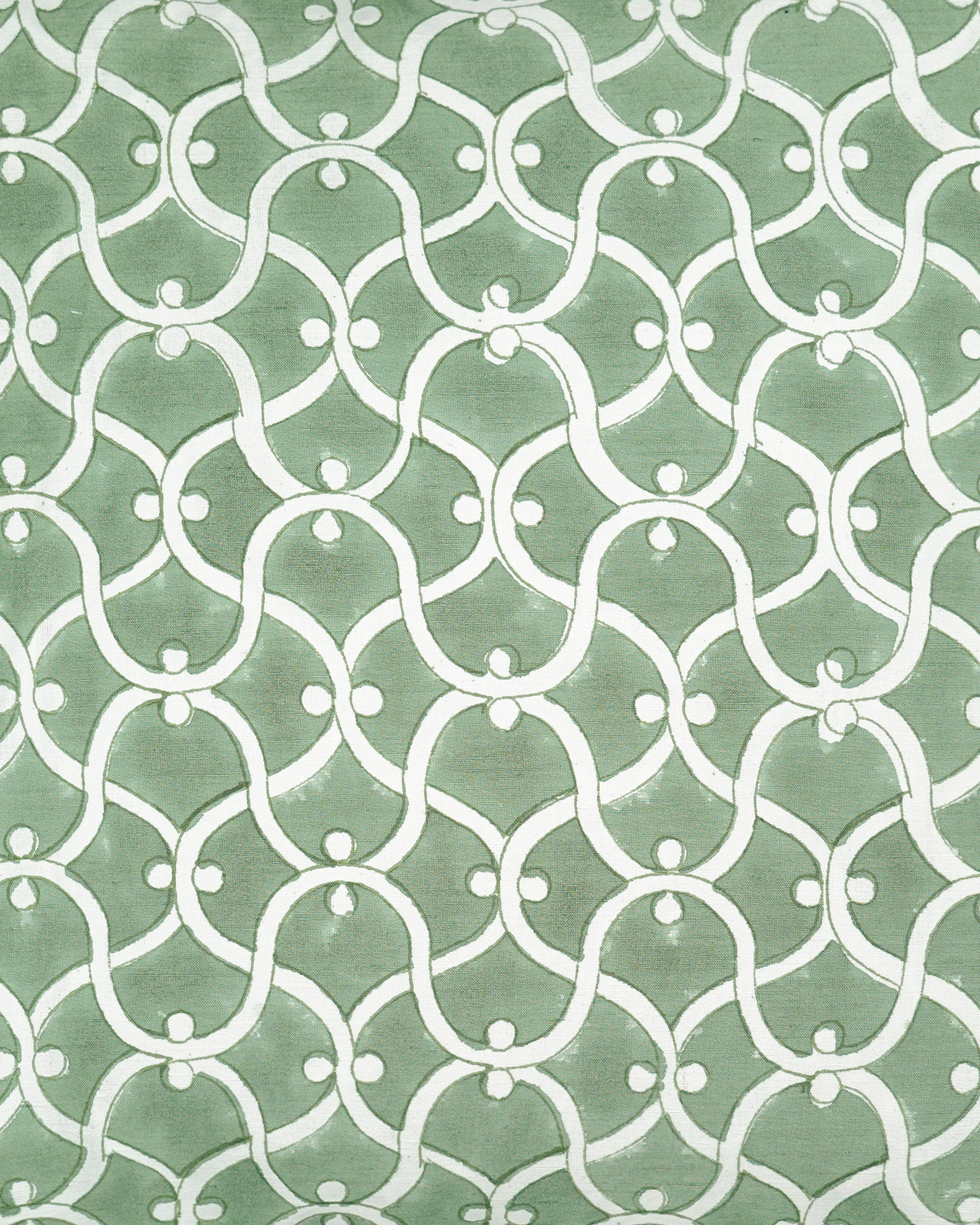 Close up detail of the green Ogee square block printed cushion with a white geometric pattern