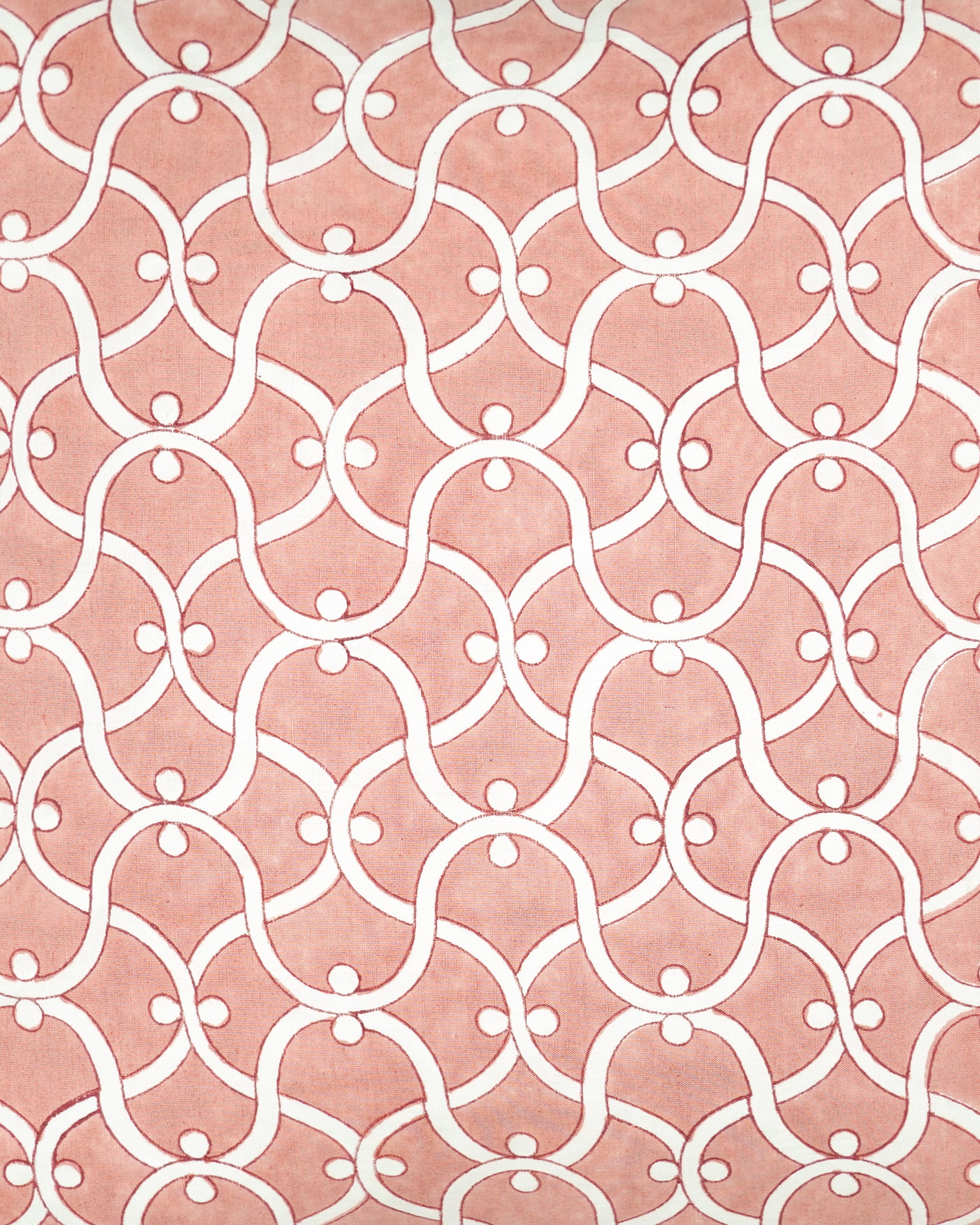 Close up detail of the pink Ogee block printed square cushion with a white geometric pattern