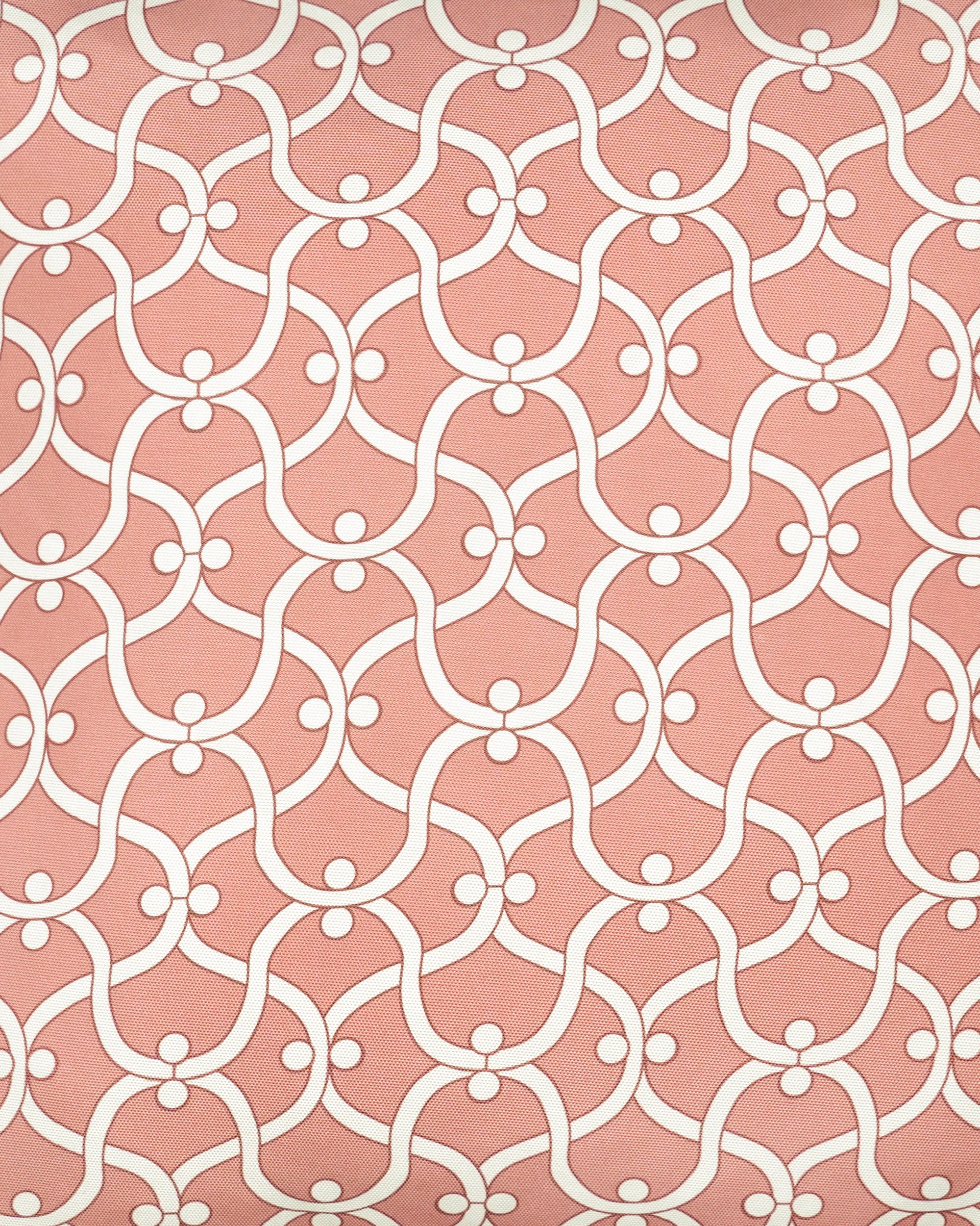 Close up detail of the Ogee outdoor cushion with a white geometric pattern on a pink background