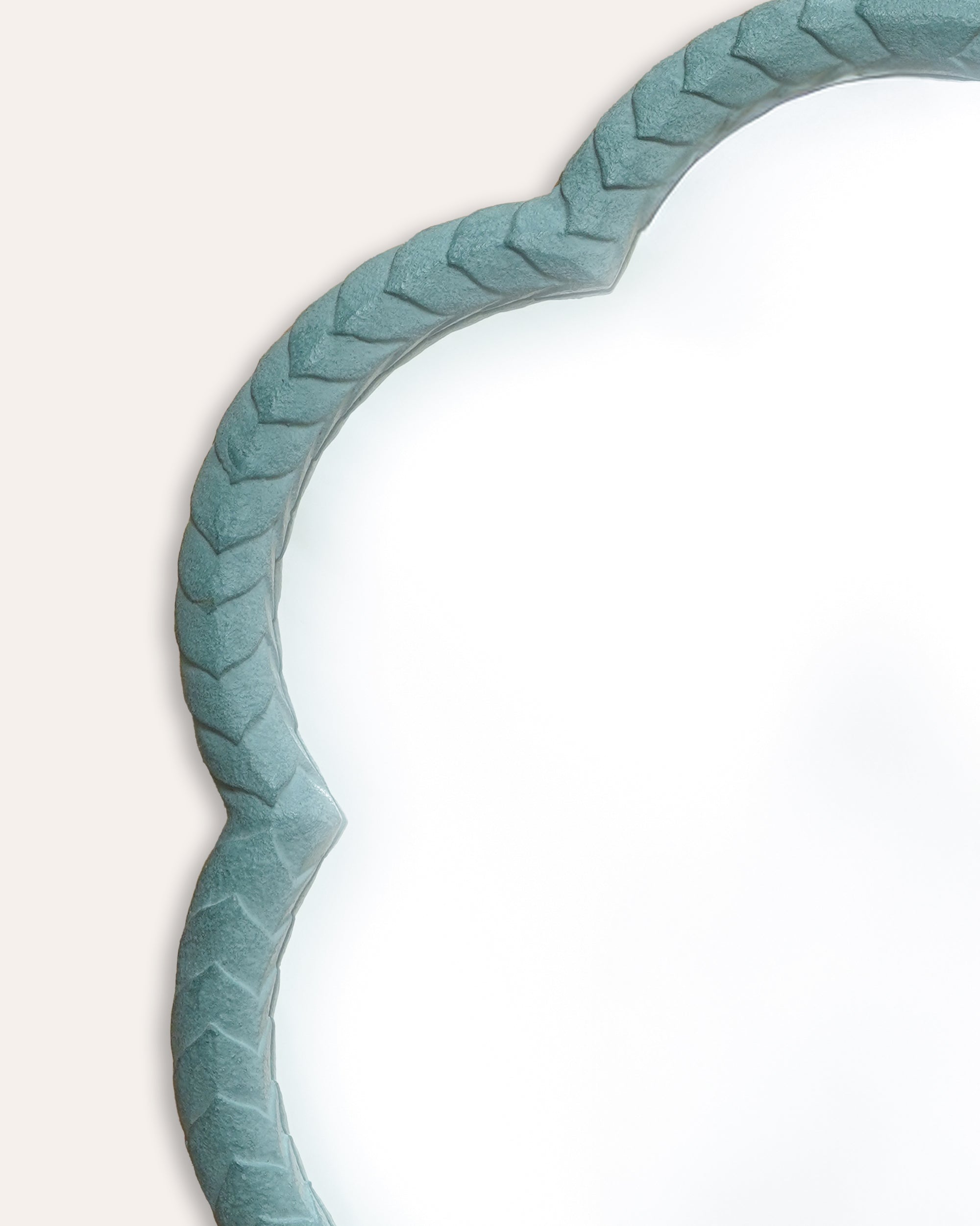 Decorative mirror with a textured light blue frame on a light background