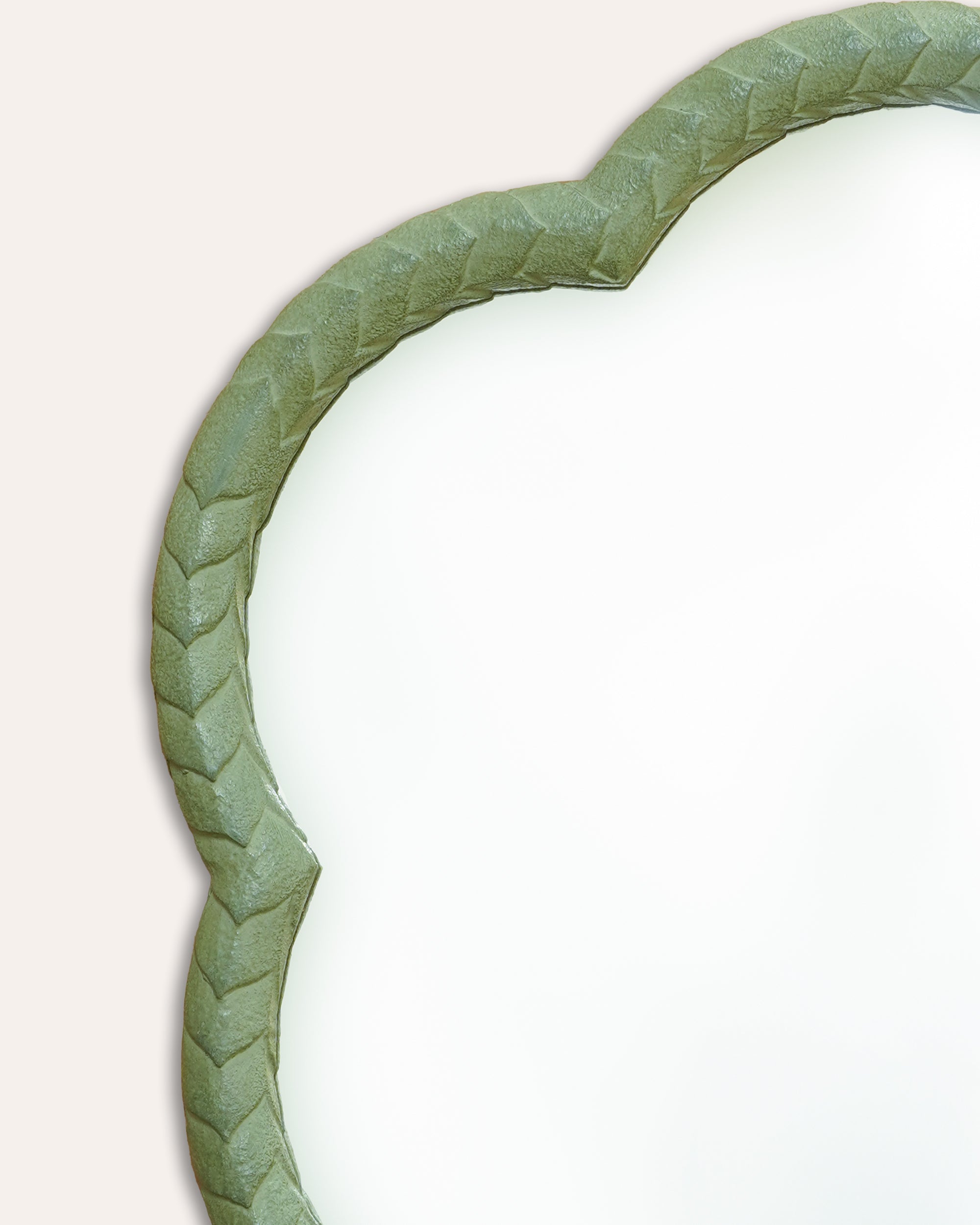 Green leaf-shaped mirror on a white background