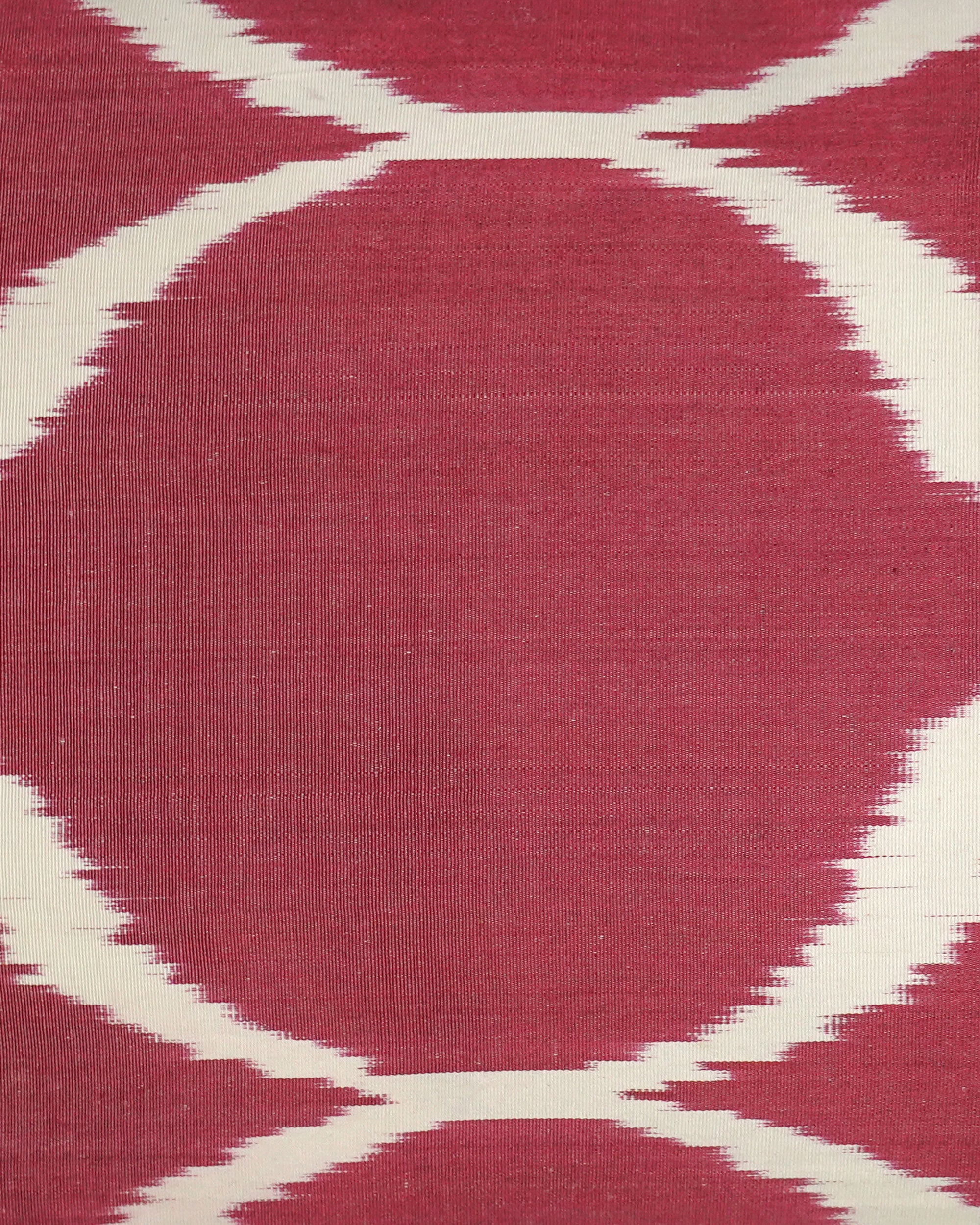Close-up of a red and white patterned Ikat cushion