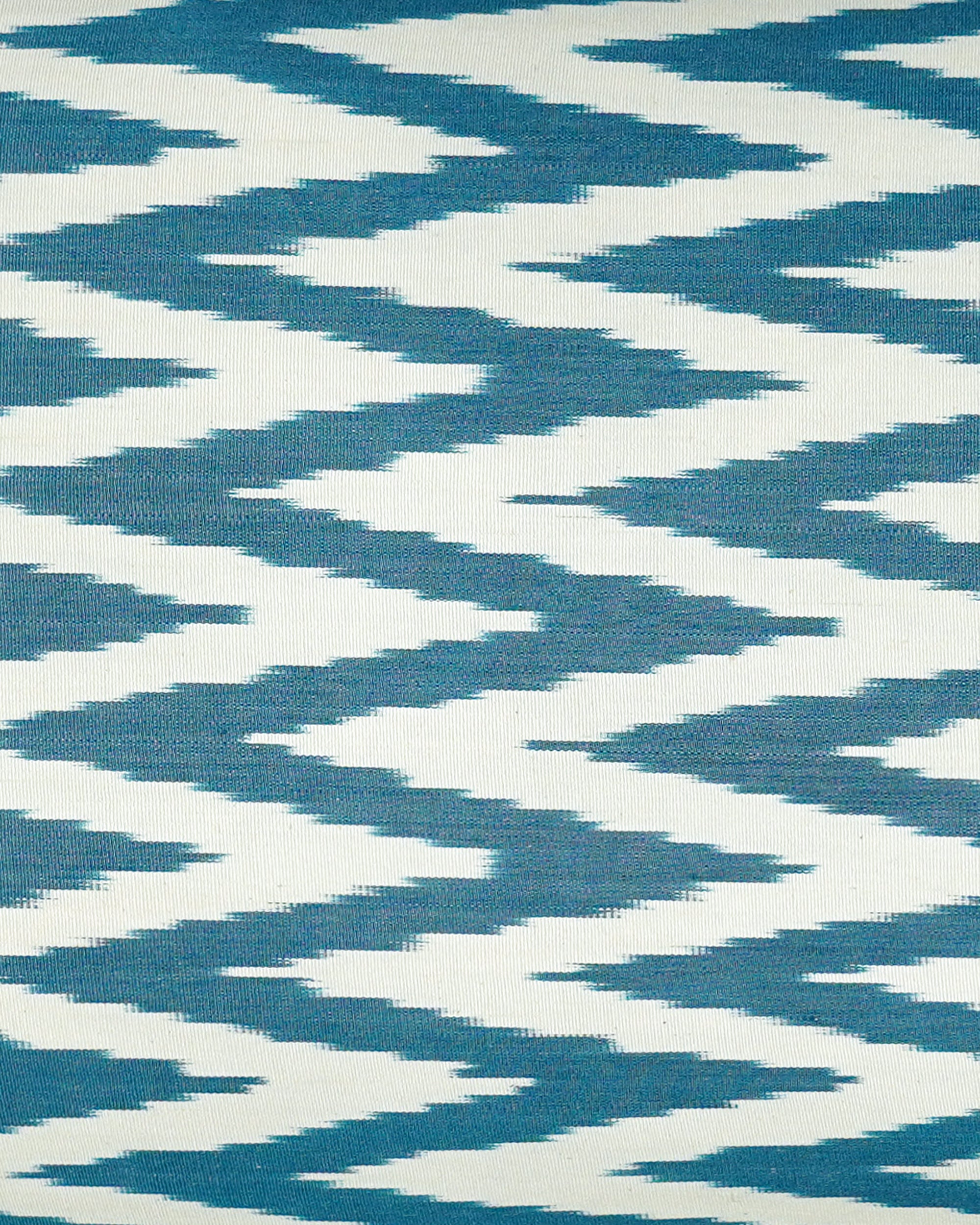 Close up detail of the Ikat patterned cushion with blue and white zigzag design