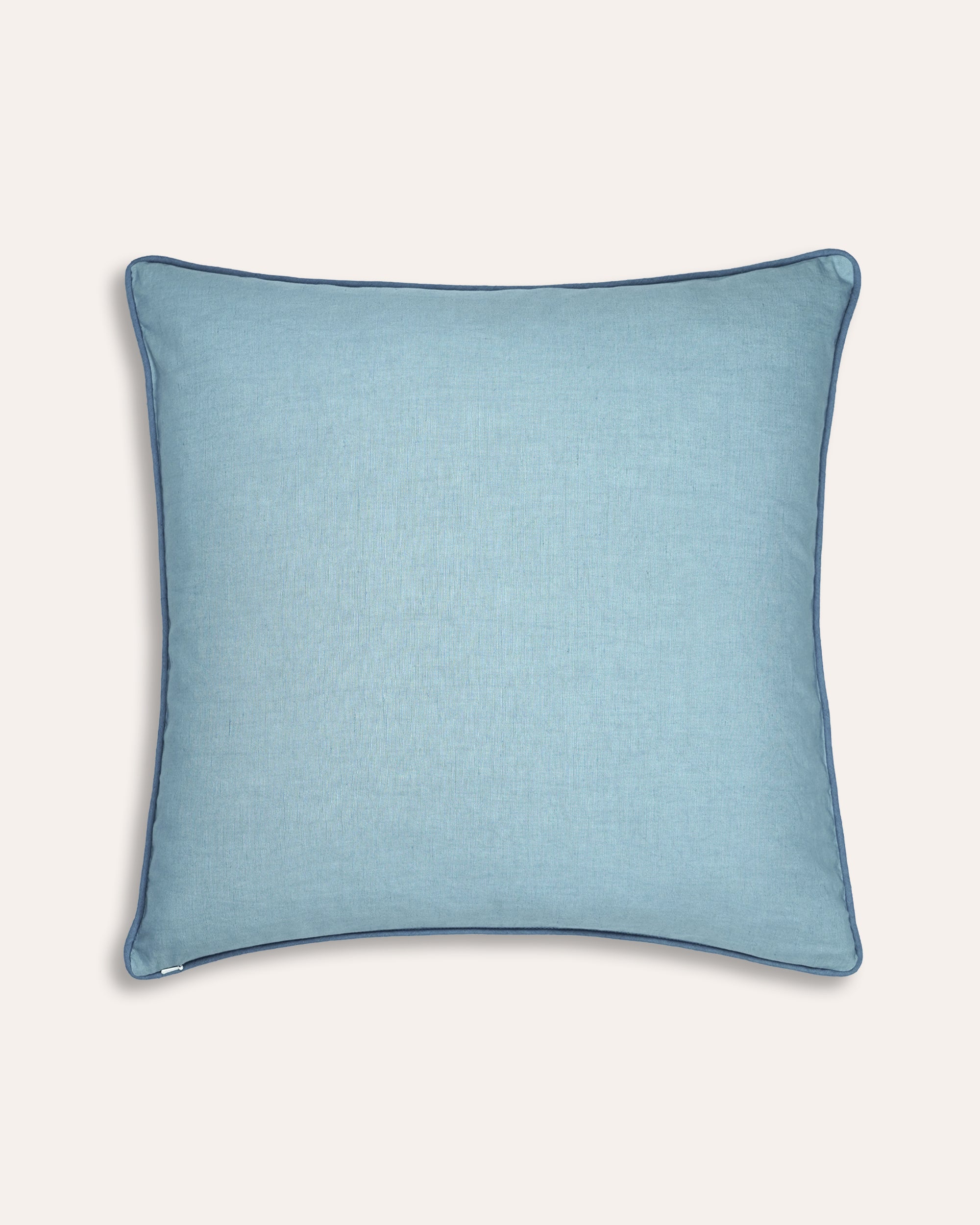 Blue square cushion back on a taupe background